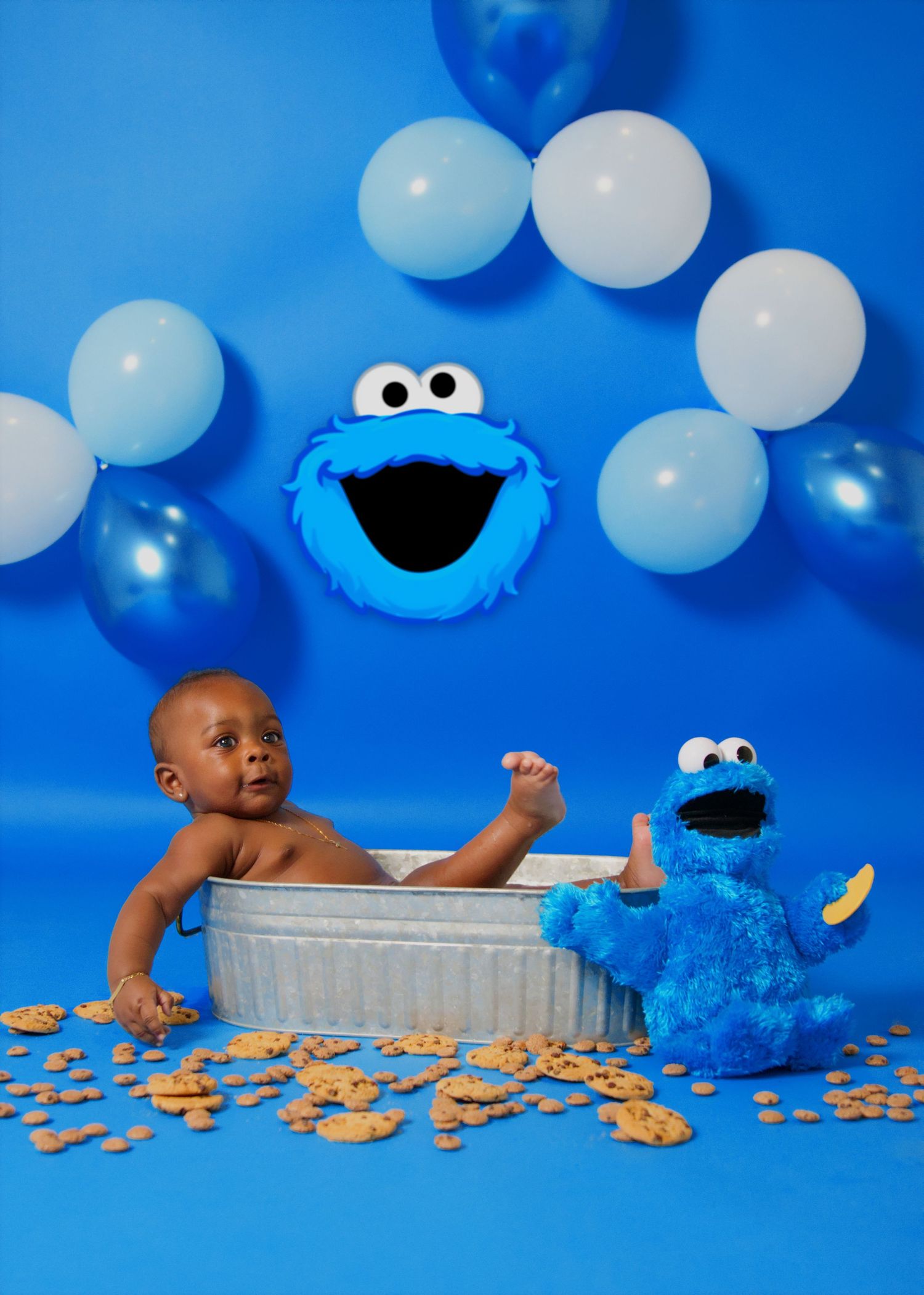 Cookie Monster themed photo setup with balloons and decorative elements.