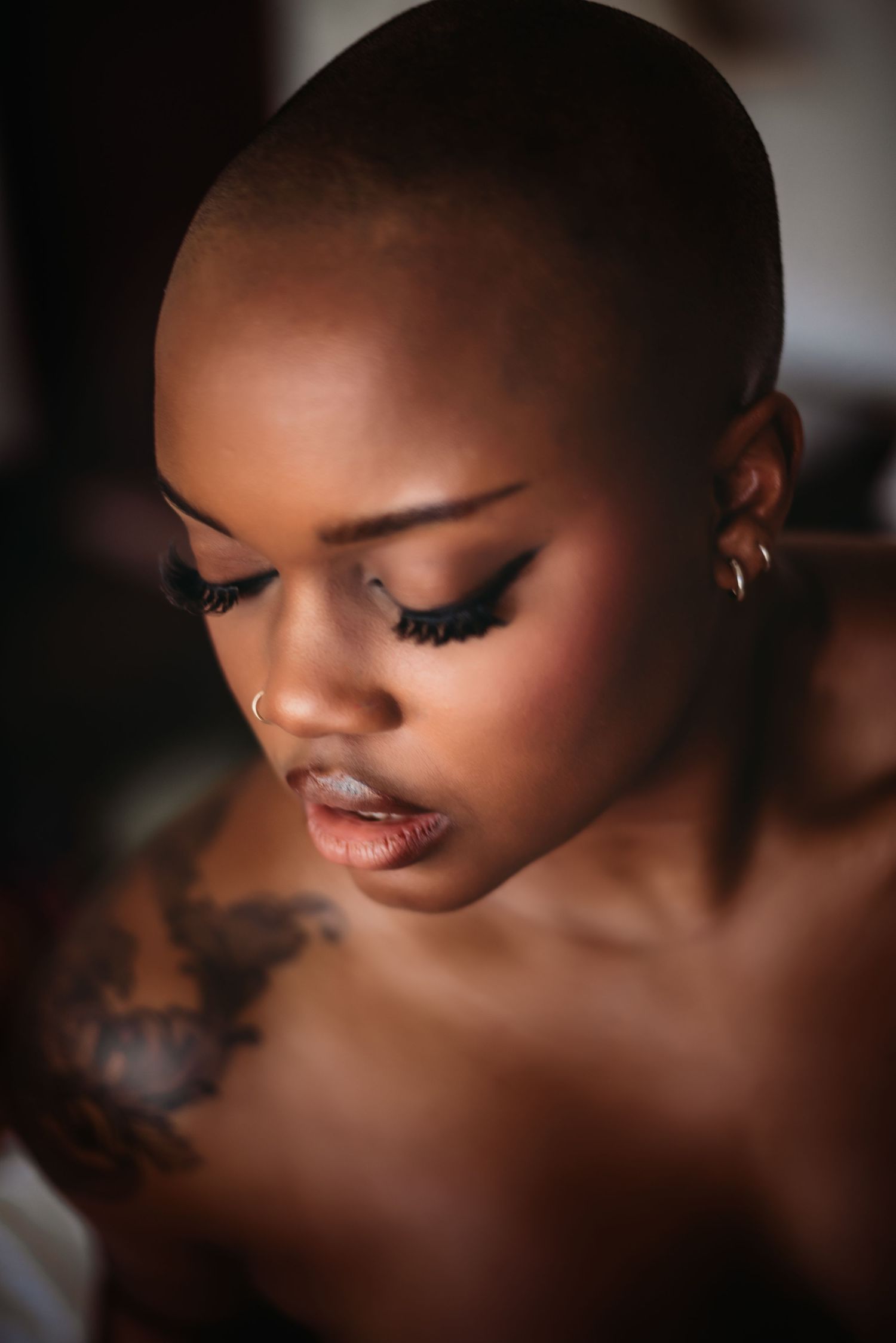 Dramatic close-up beauty portrait with soft lighting and long eyelashes.