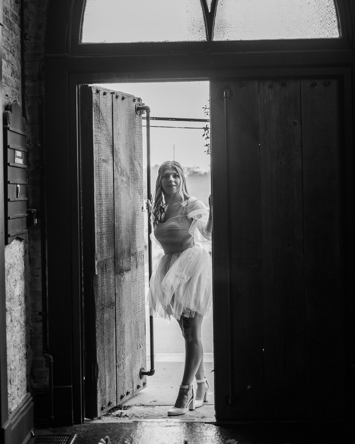 Black and white architectural wedding photos with dramatic window lighting.