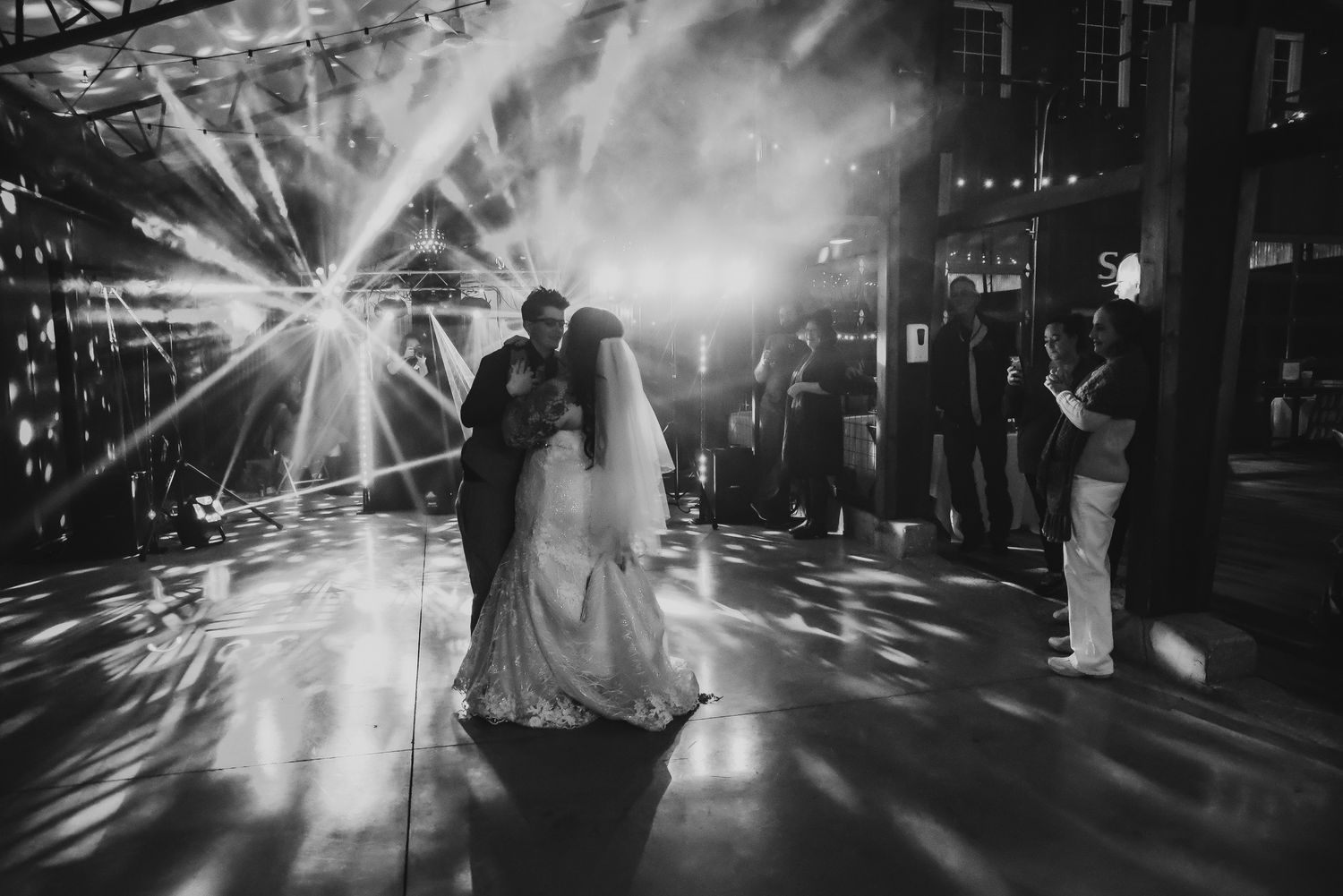 Dramatic nighttime wedding photos with light bursts and silhouettes.