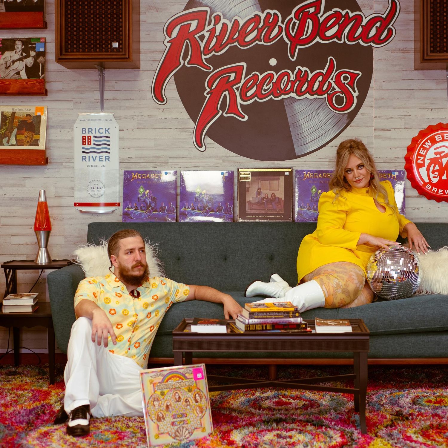 Record store interior with yellow and red decor and comfortable seating area.