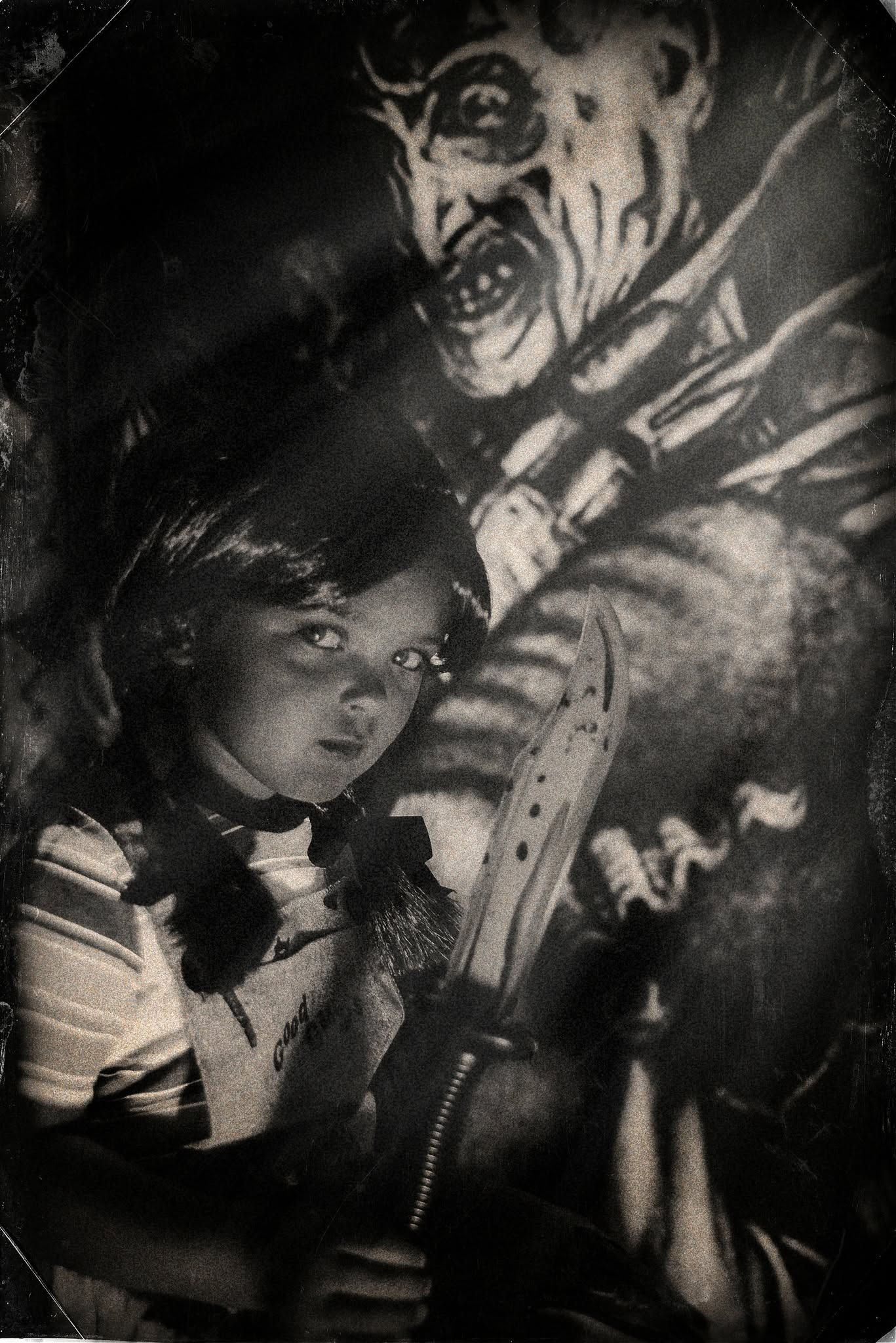 Vintage black and white photo of a young girl holding a knife with a terrifying monster looming behind her.