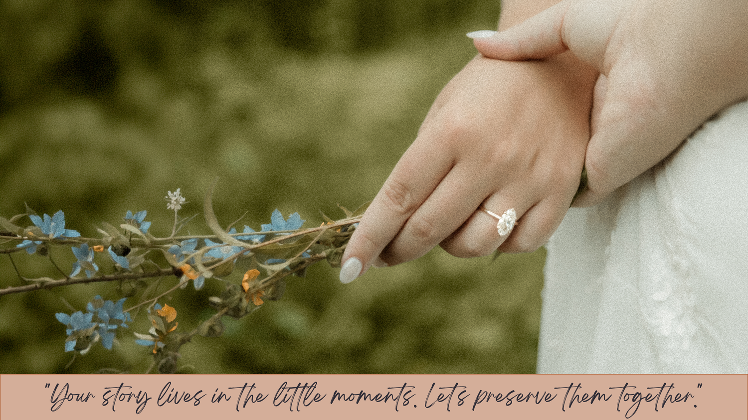 Close-up of a bride's hand wearing an engagement ring, gently holding blue wildflowers outdoors.