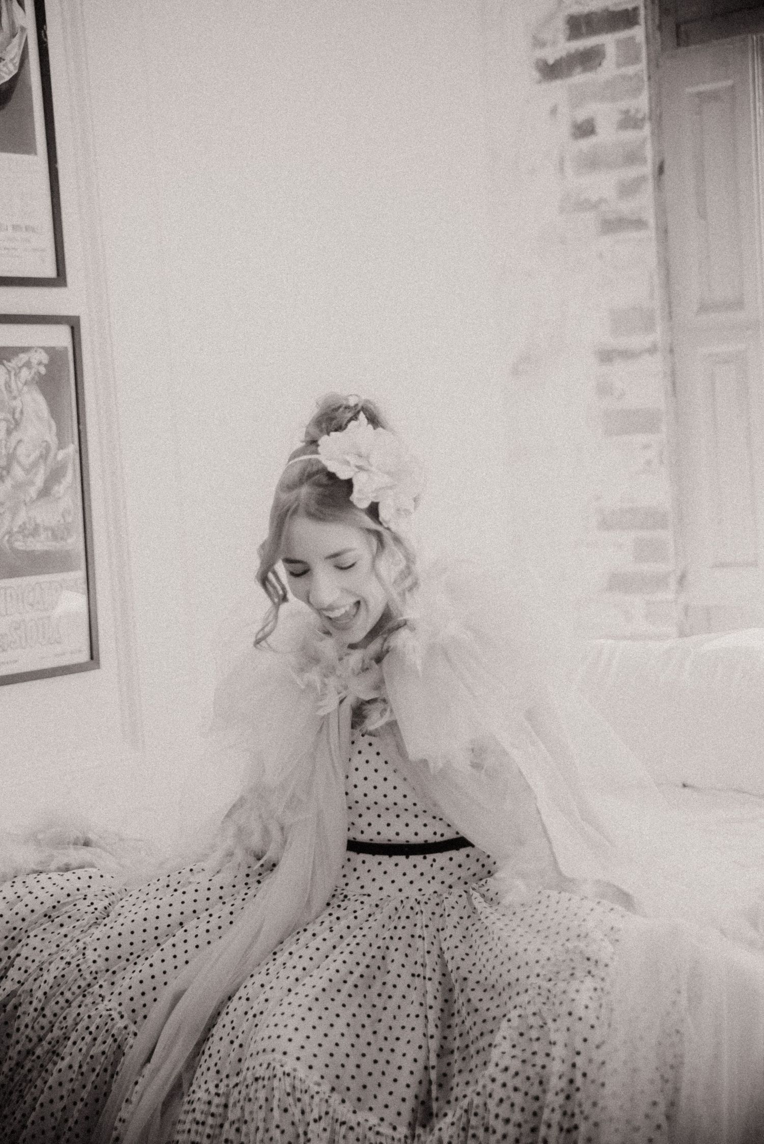 Vintage-style portrait of woman in polka dot dress and veil.