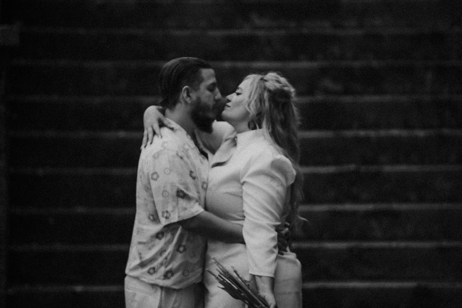 Black and white romantic portrait on stone steps.