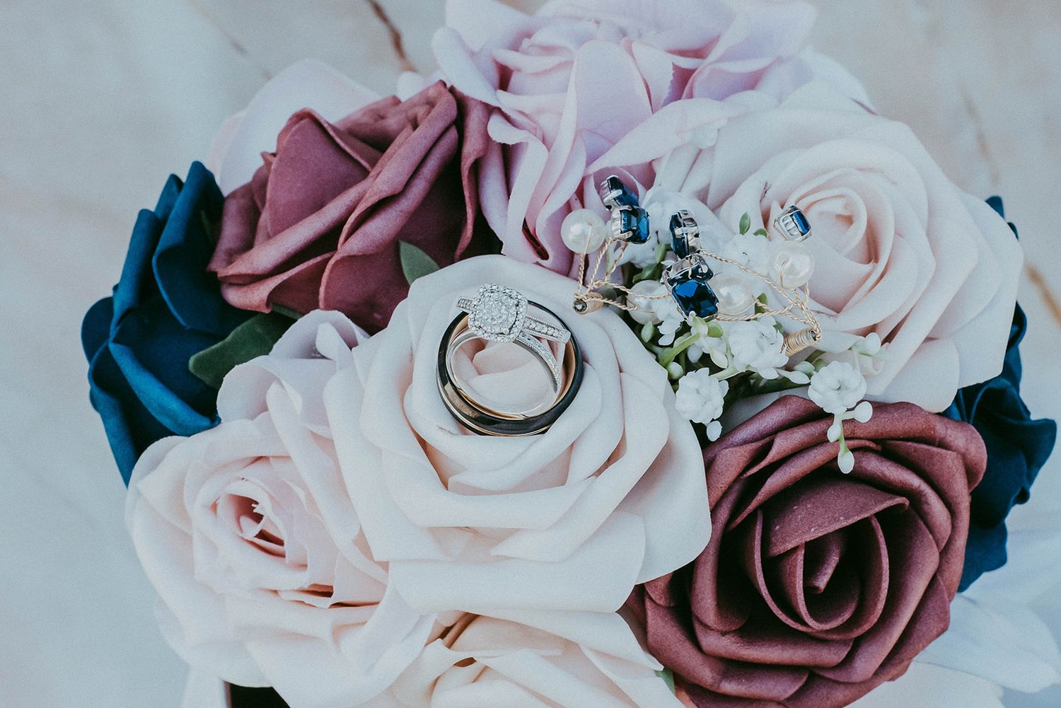 Close-up of delicate pink and mauve roses arranged in an elegant bouquet.