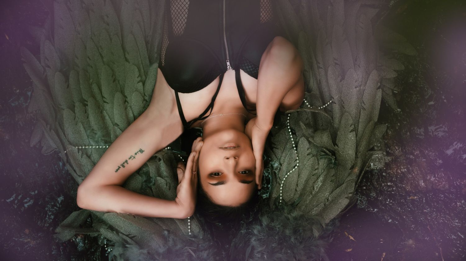 Artistic boudoir photography with purple lighting effects and dramatic shadows.