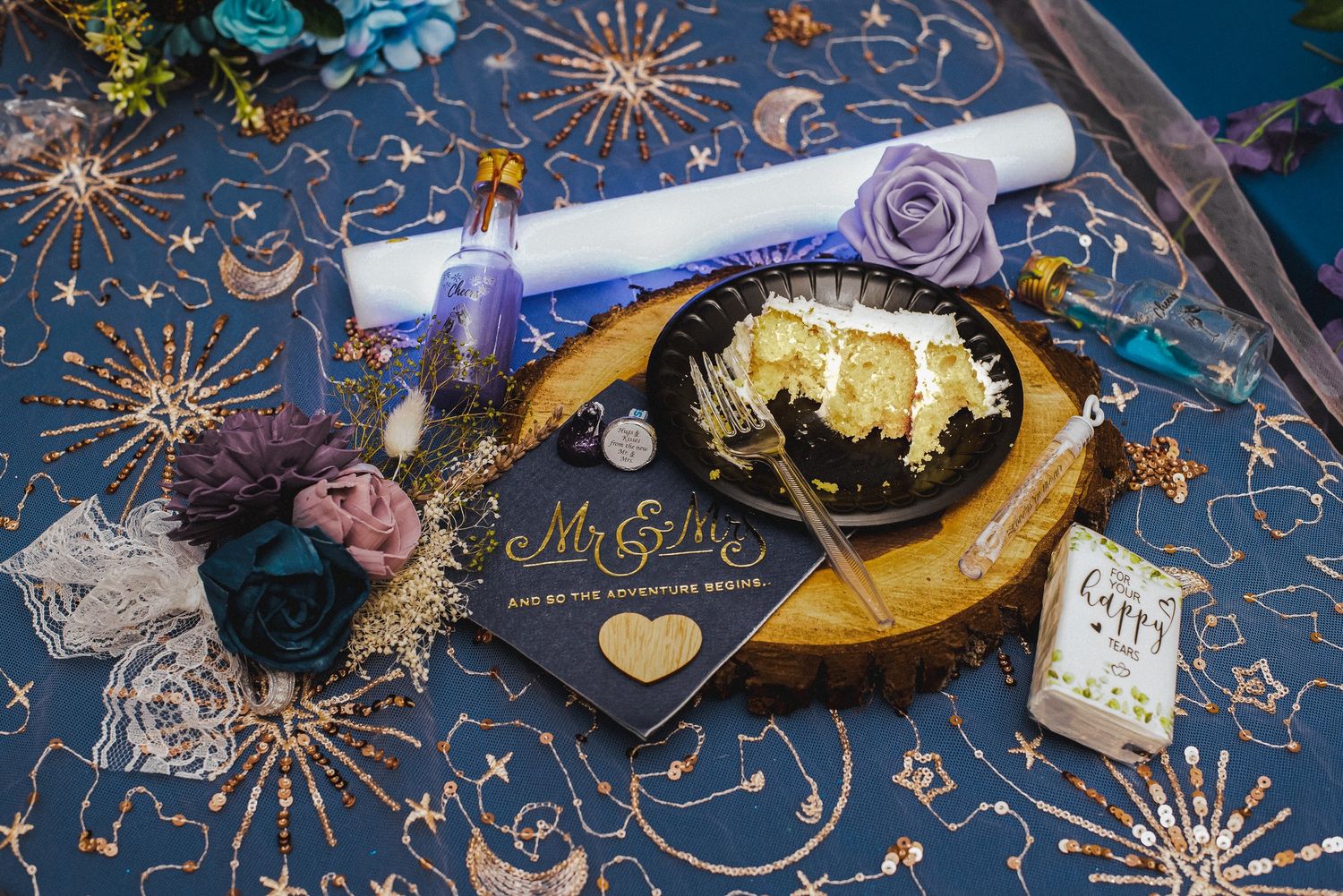 Decorative navy blue party supplies with gold stars and sparklers create a festive celebration display.