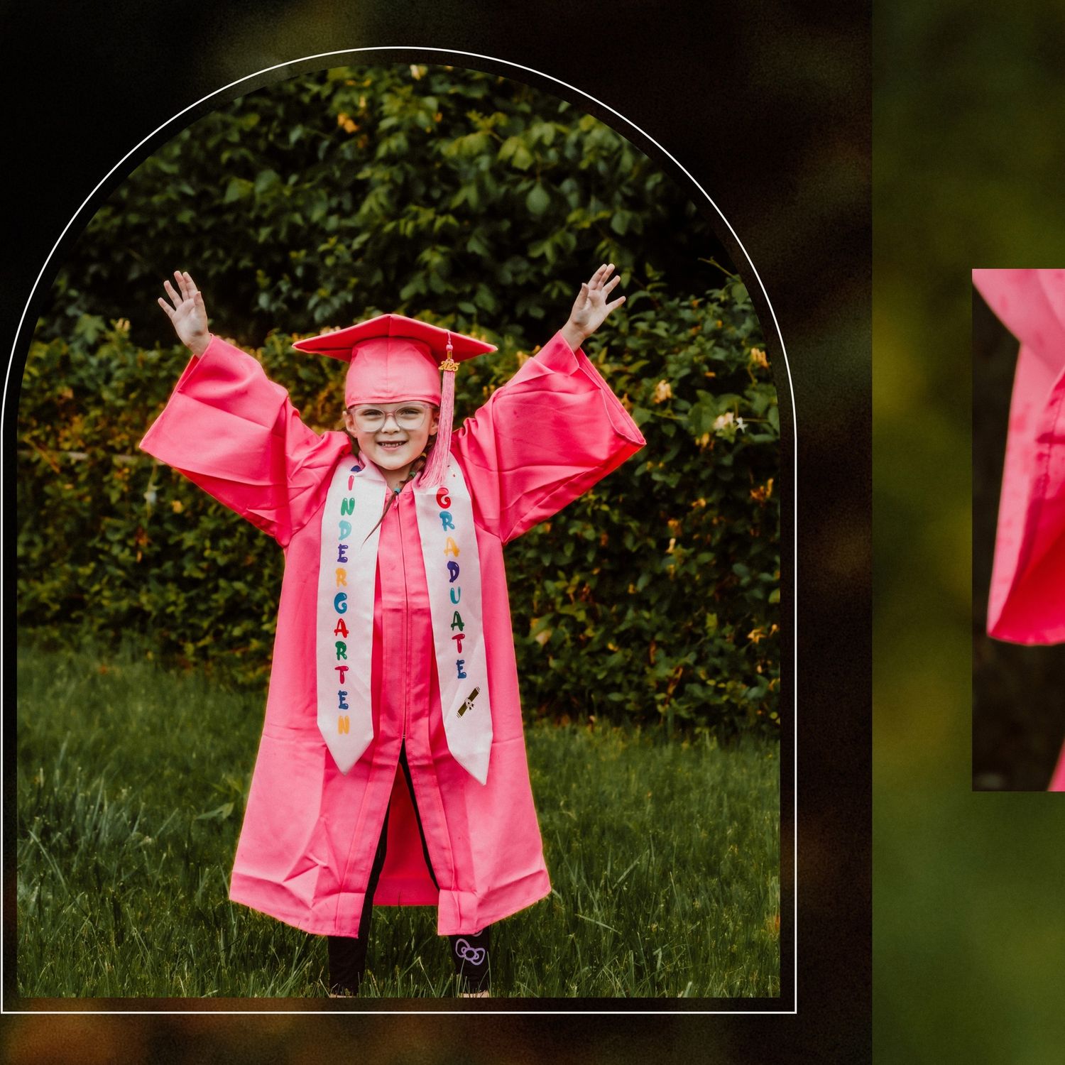 Graduate in bright pink graduation gown celebrating outdoors with arms raised.