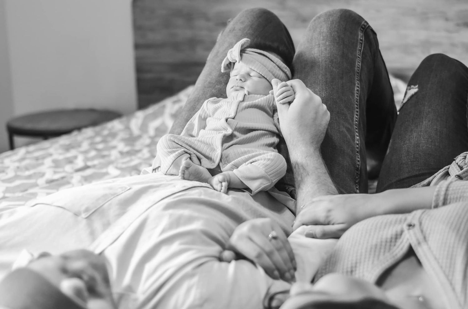 Intimate black and white lifestyle portraits on bed showing tender moments.