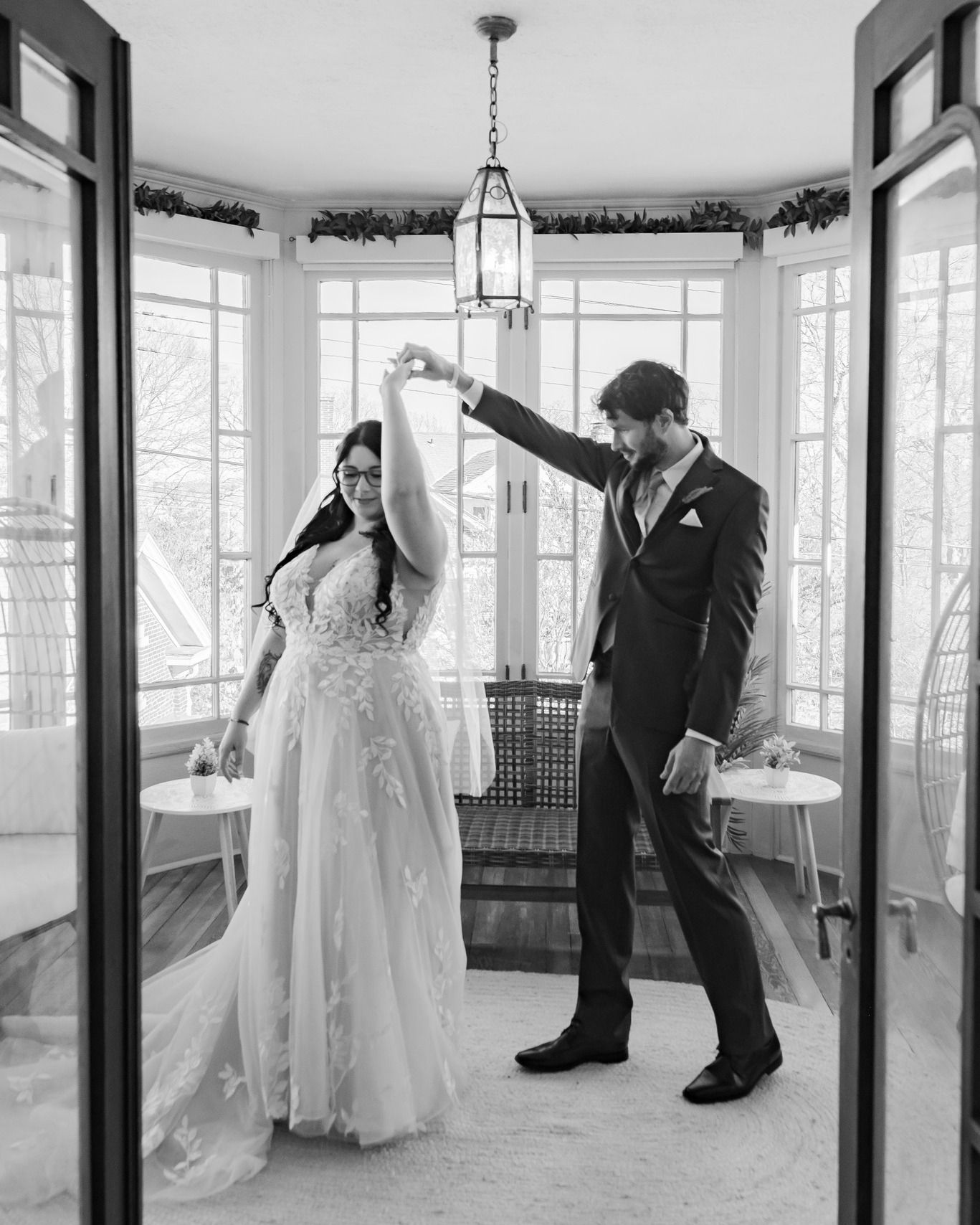 Black and white panoramic wedding photos showing dancing silhouettes in an elegant venue.