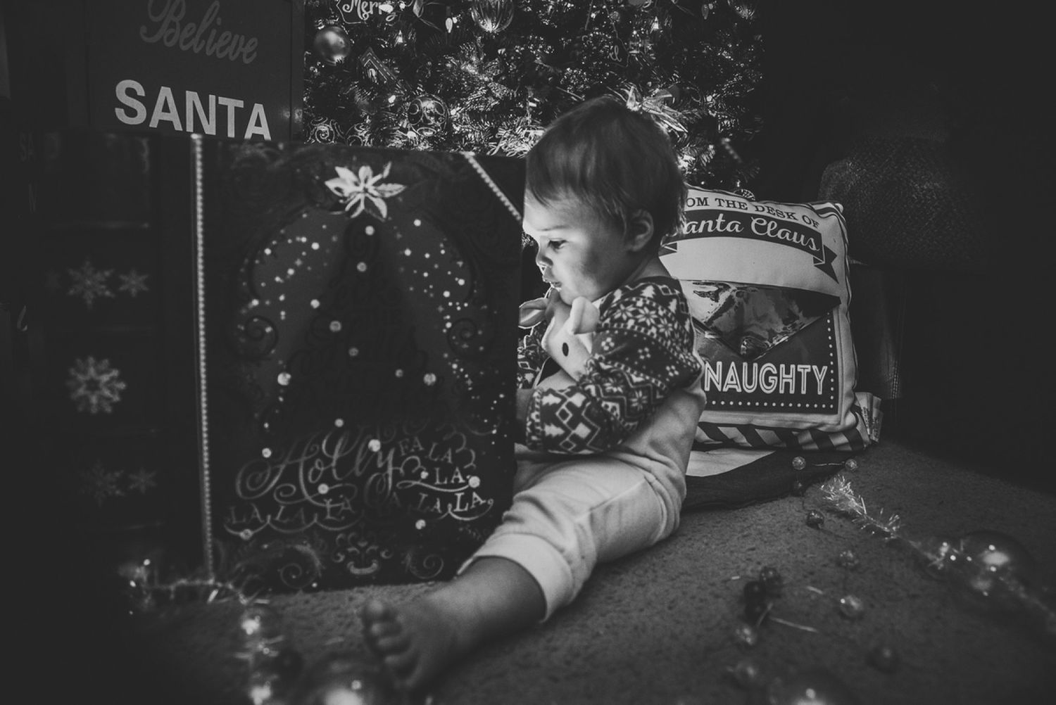 Black and white photo of Christmas scene with Santa sign and decorative snowflakes.