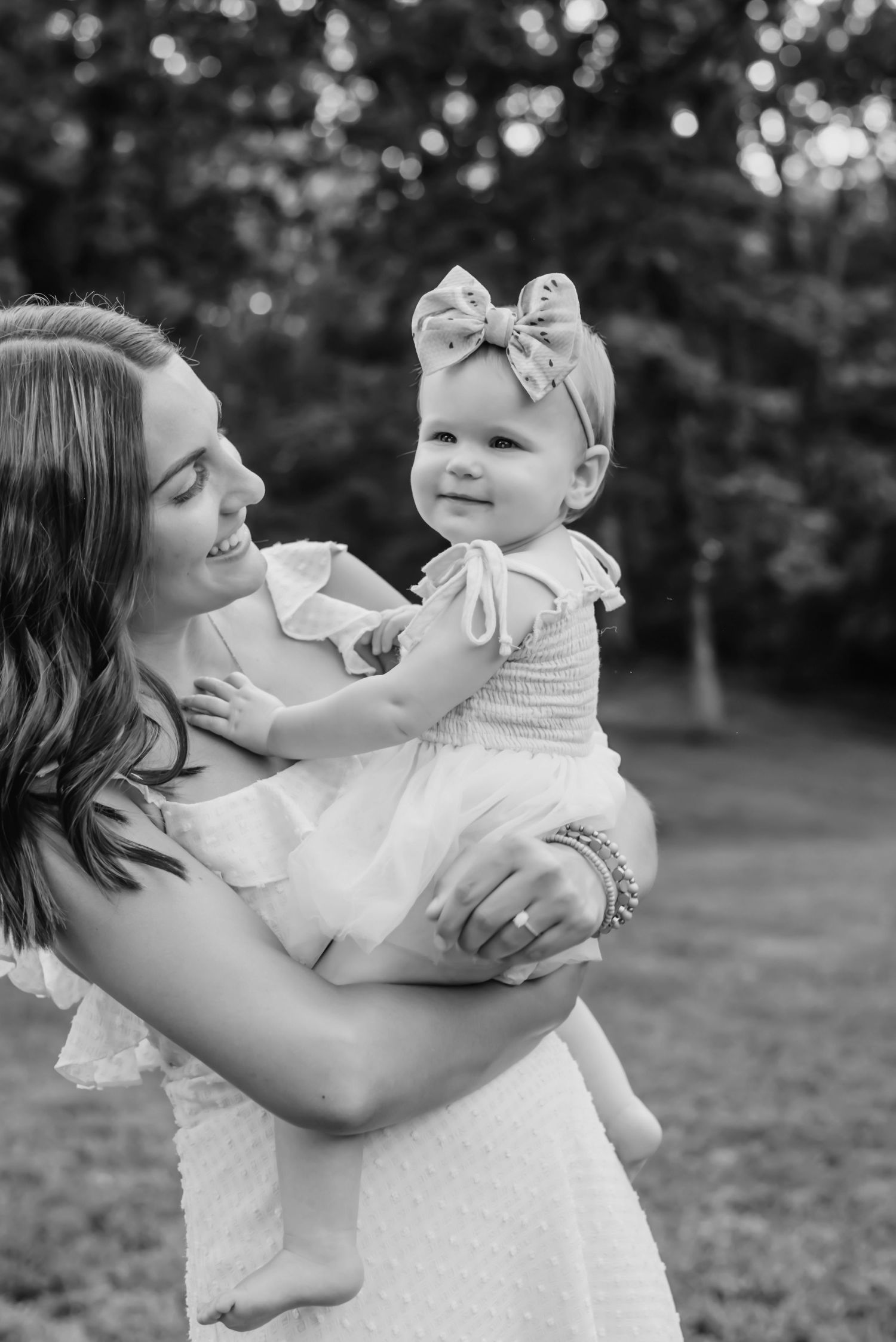 Sweet outdoor portrait in black and white showing gentle embrace and smiles.