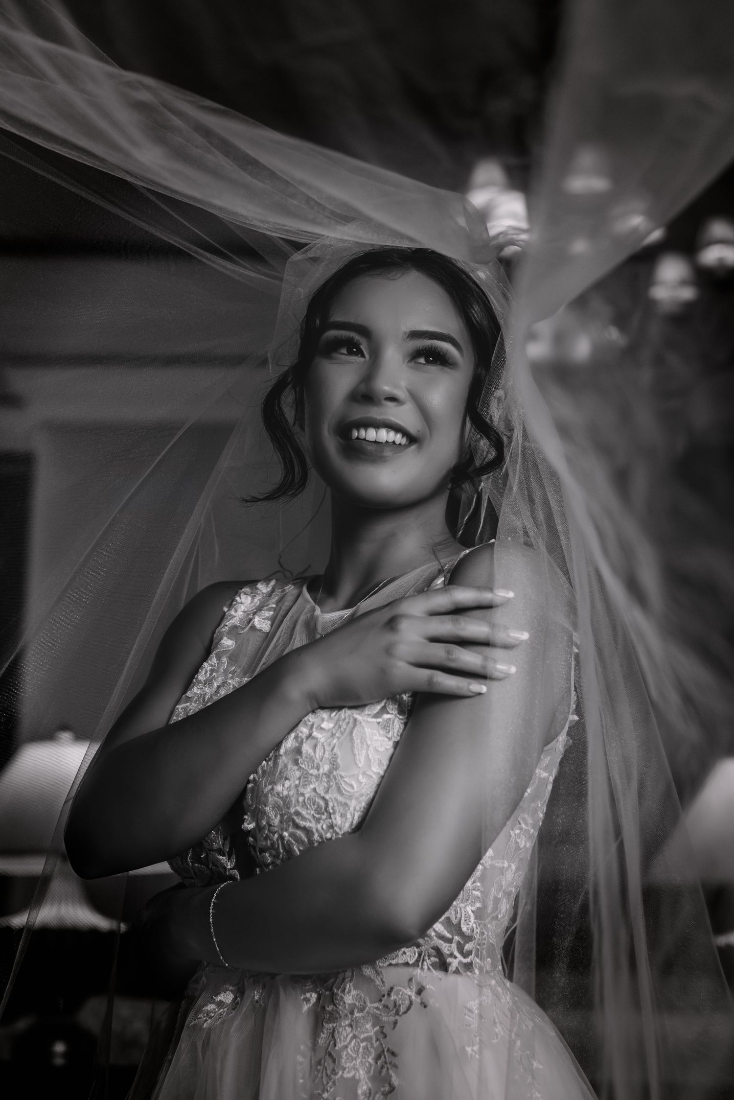 Black and white wedding photography sequence featuring flowing veil and joyful moments.