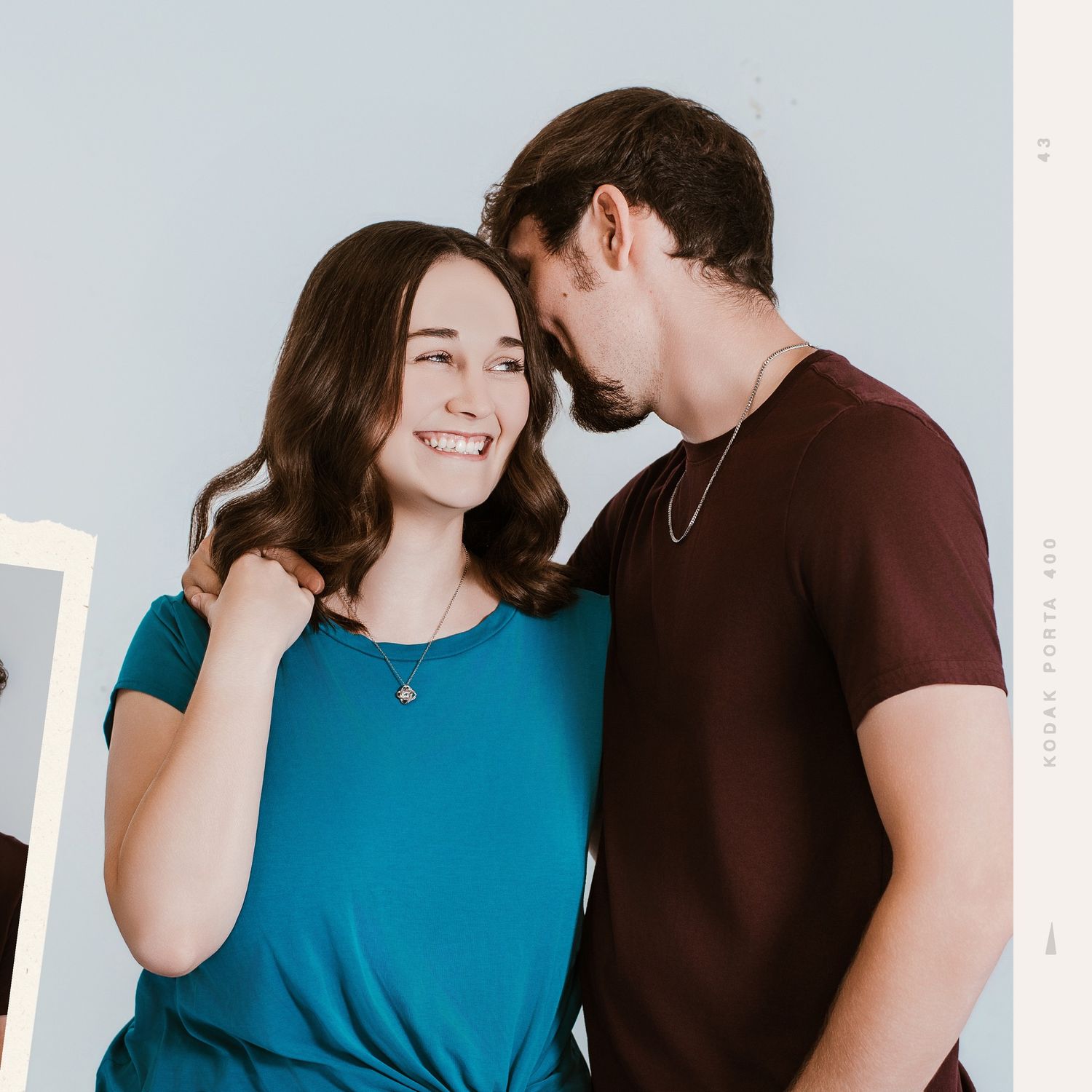 Couple in casual wear sharing joyful moments during photo session.