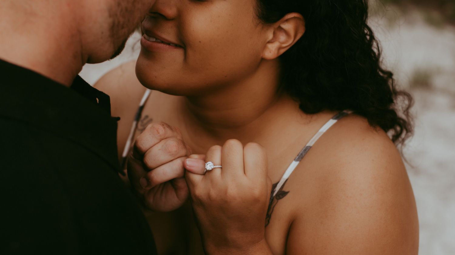Intimate close-up silhouette of a couple sharing a tender moment.