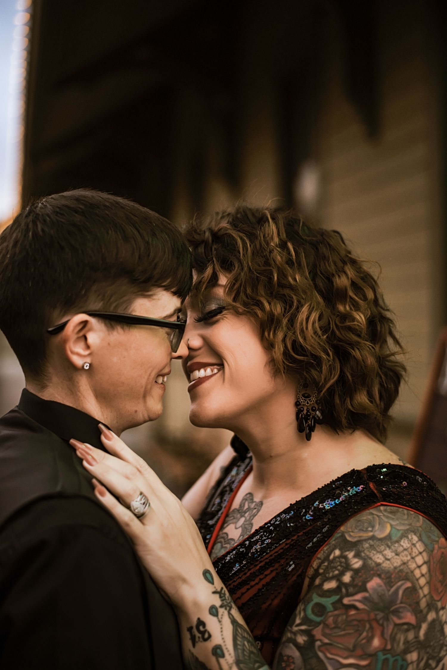 Intimate close-up portraits showing affection in dark moody lighting.