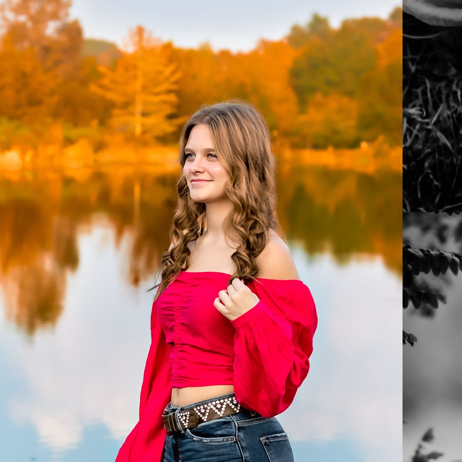 Portrait by water featuring red off-shoulder top against autumn trees and reflective lake.