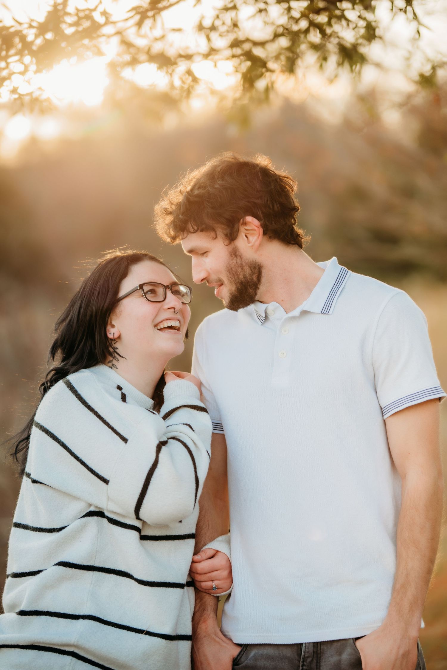 Couple shares intimate moments during golden hour photoshoot in casual attire.