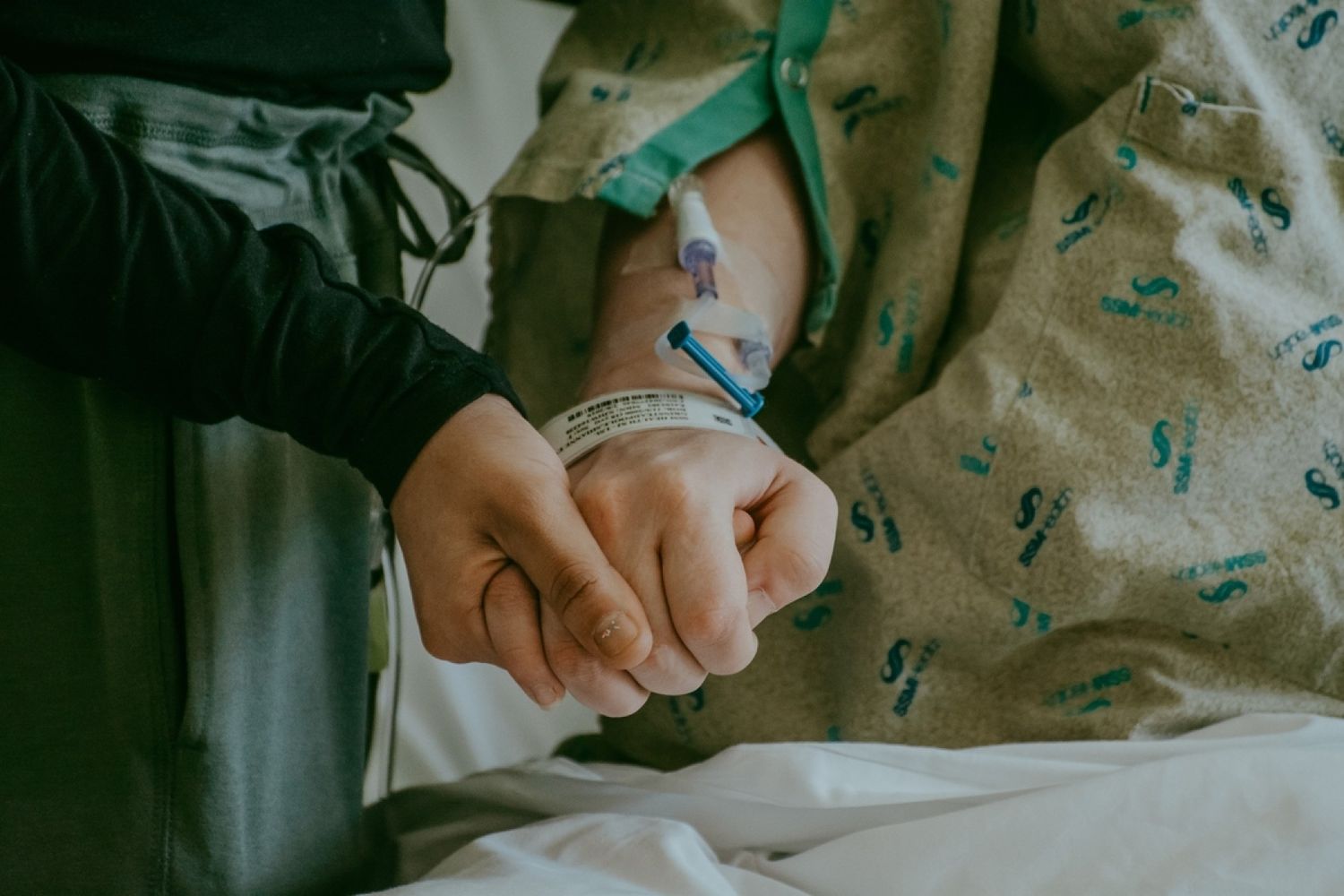 Close-up of hands holding medical equipment in a hospital setting.