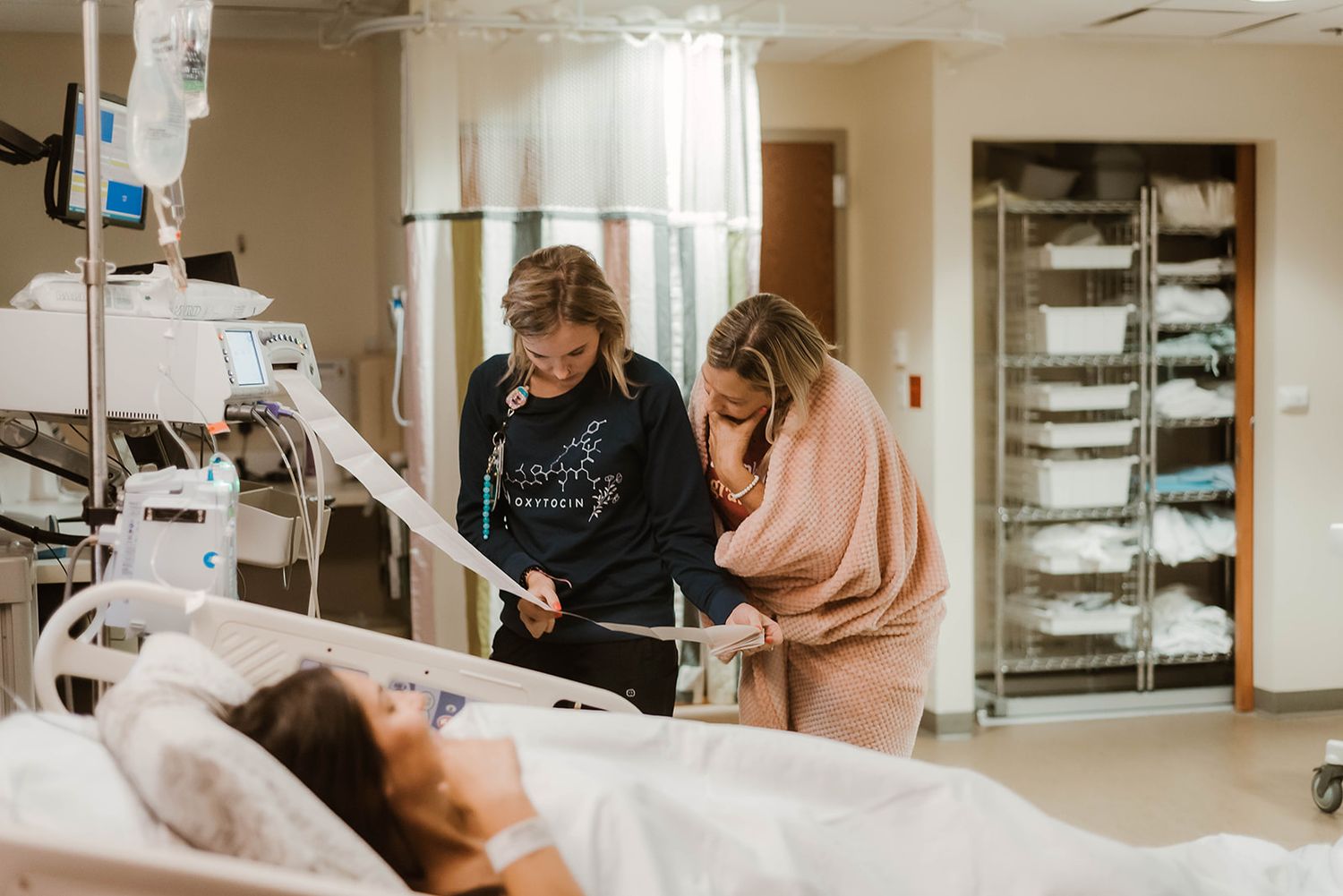 Medical staff reviewing documents in a clinical setting with modern equipment.