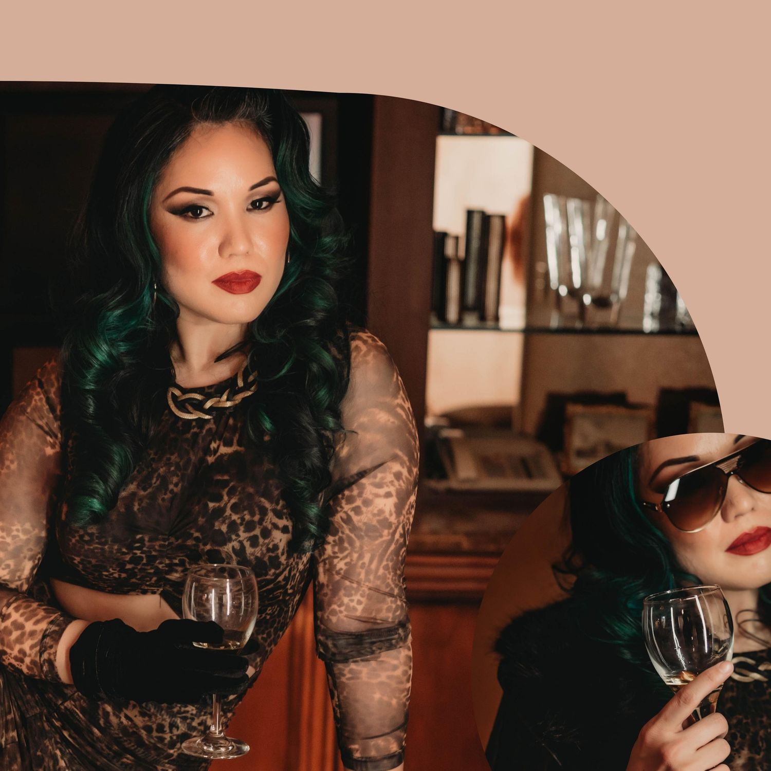 A woman in black lace holds a wine glass during an elegant boudoir photoshoot.