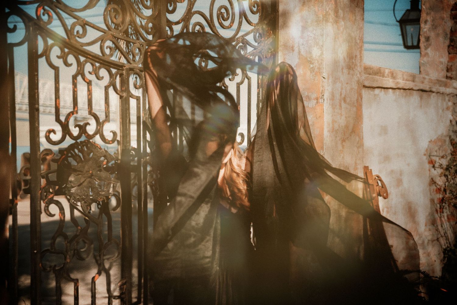 Artistic photography with decorative iron scrollwork creating shadowed patterns.