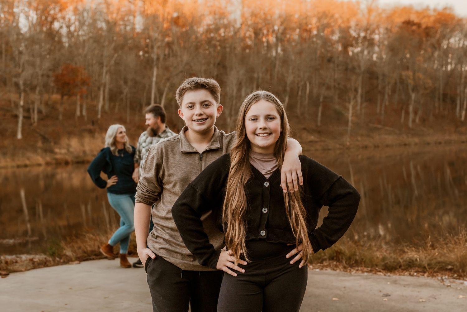 Outdoor autumn family photography session with warm sepia tones and natural lighting.