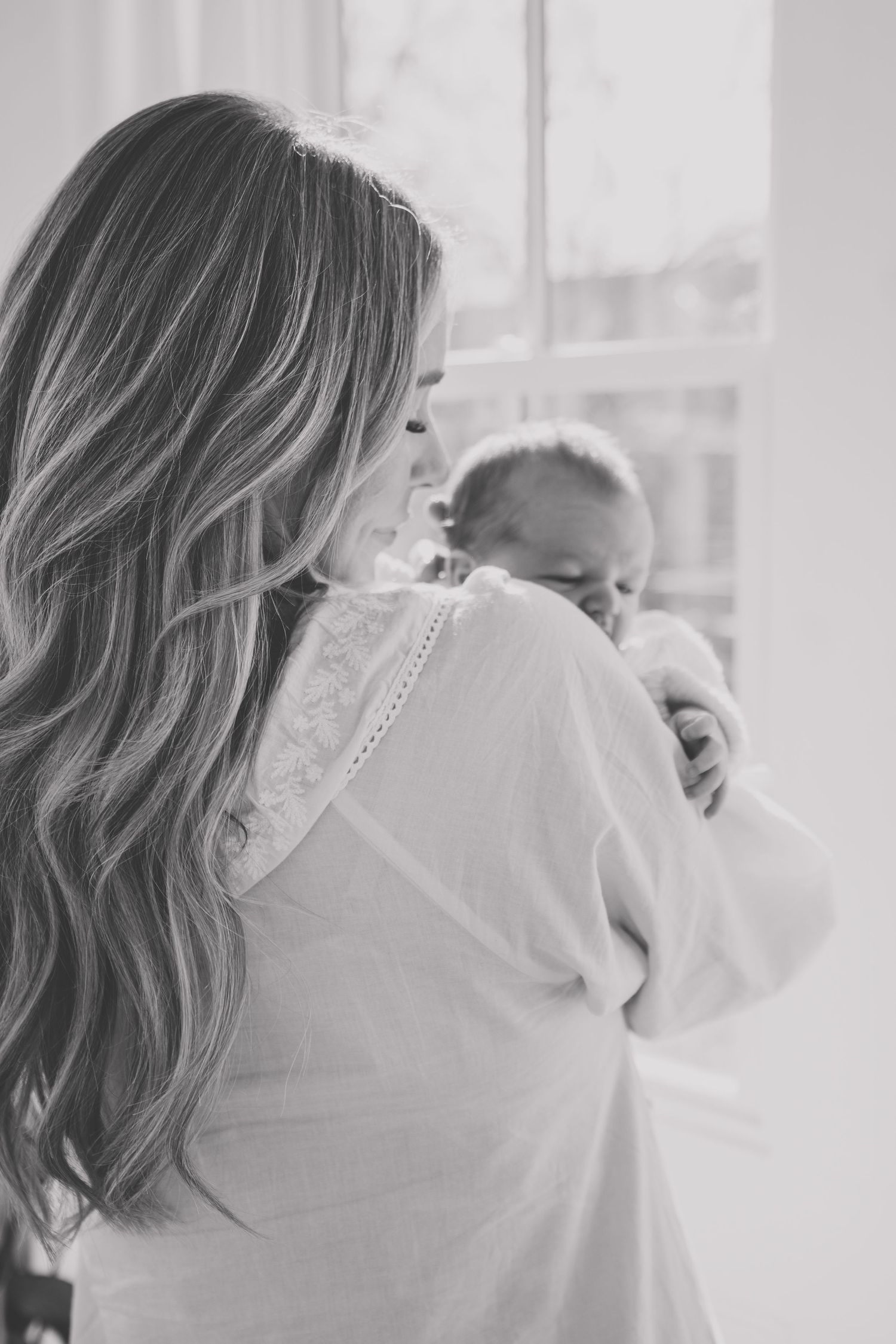 Intimate family moments captured in soft, natural window light.