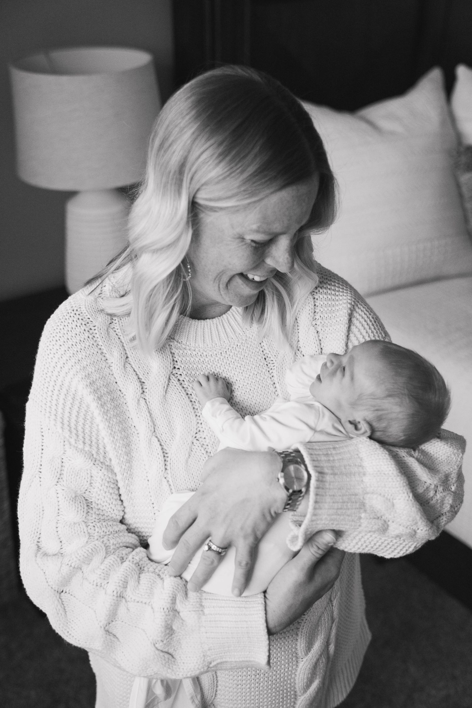 Black and white series showing tender moments between parent and newborn.
