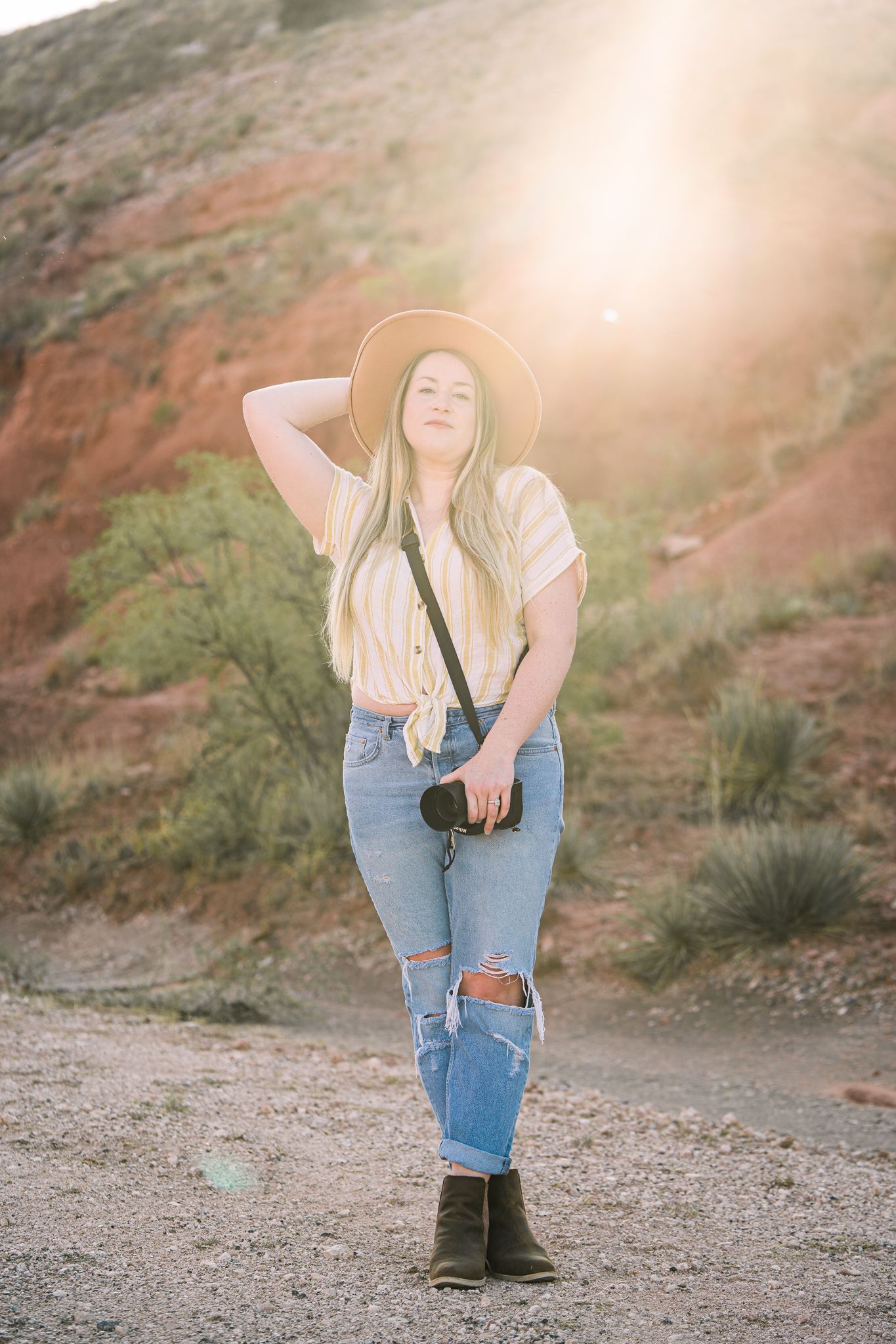 Artistic photo sequence of person in ripped jeans posing against desert backdrop in golden sunlight.
