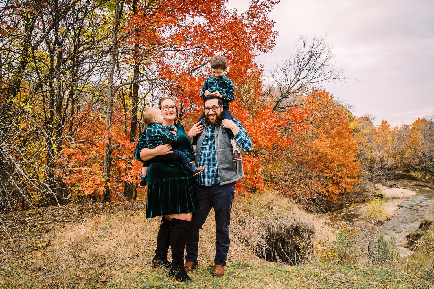 A sequence of candid outdoor shots showing a family enjoying a nature walk among colorful autumn trees and leaves.