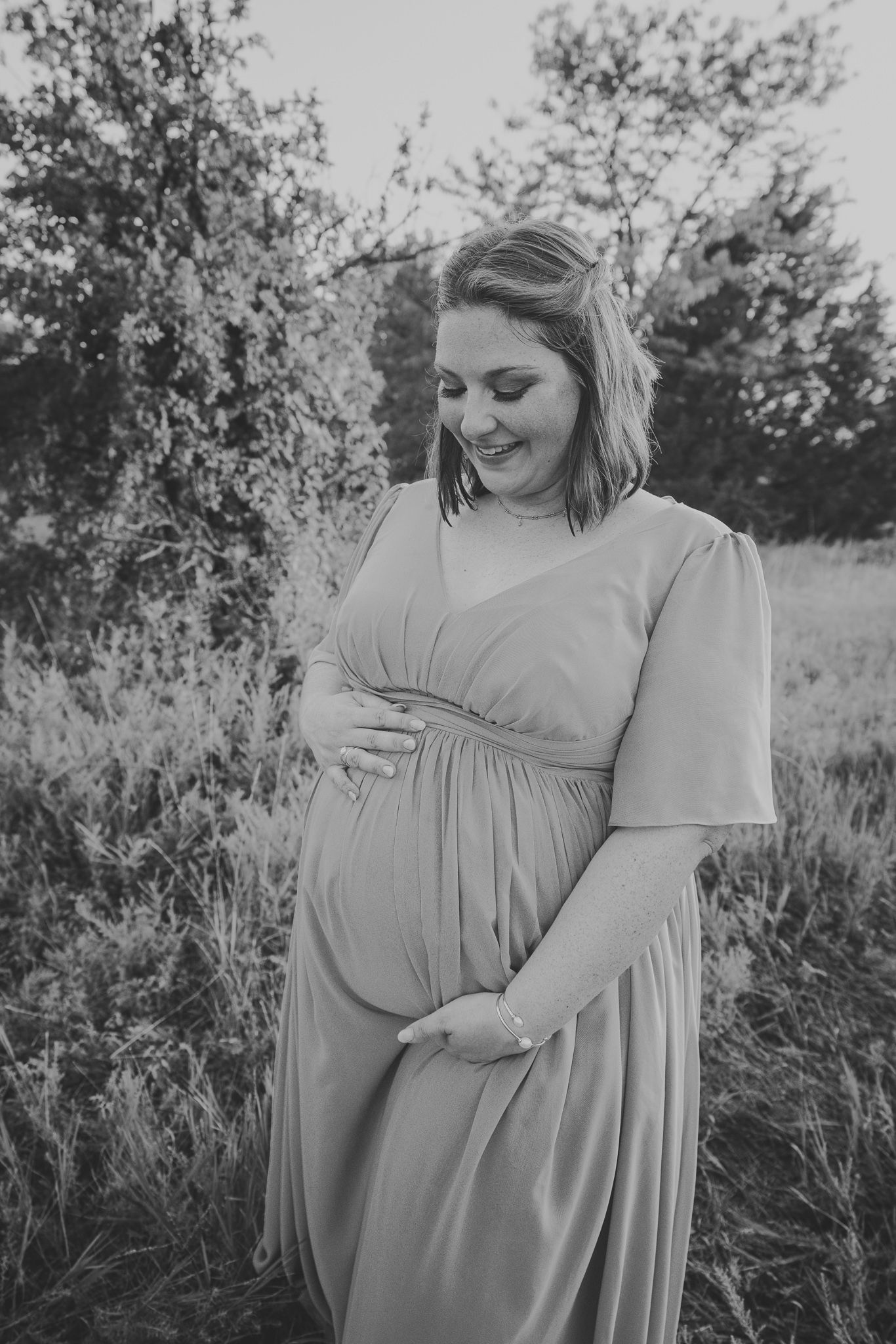 Black and white maternity portraits showing gentle moments and natural expressions.