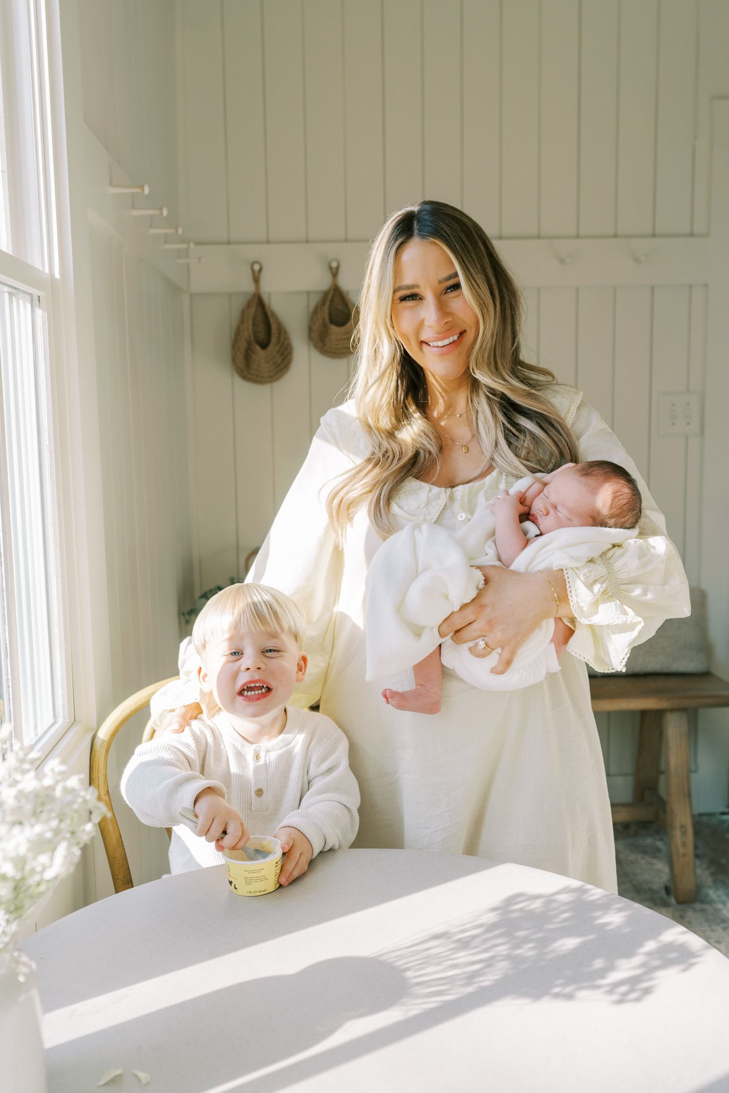 Lifestyle family photography session showing joyful interactions in a bright white room.