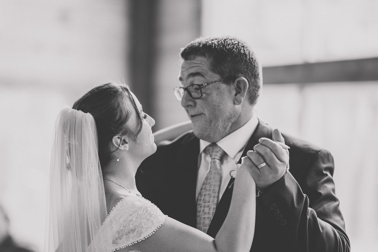 A black and white wedding photo collage showing intimate moments between couples during their special day.