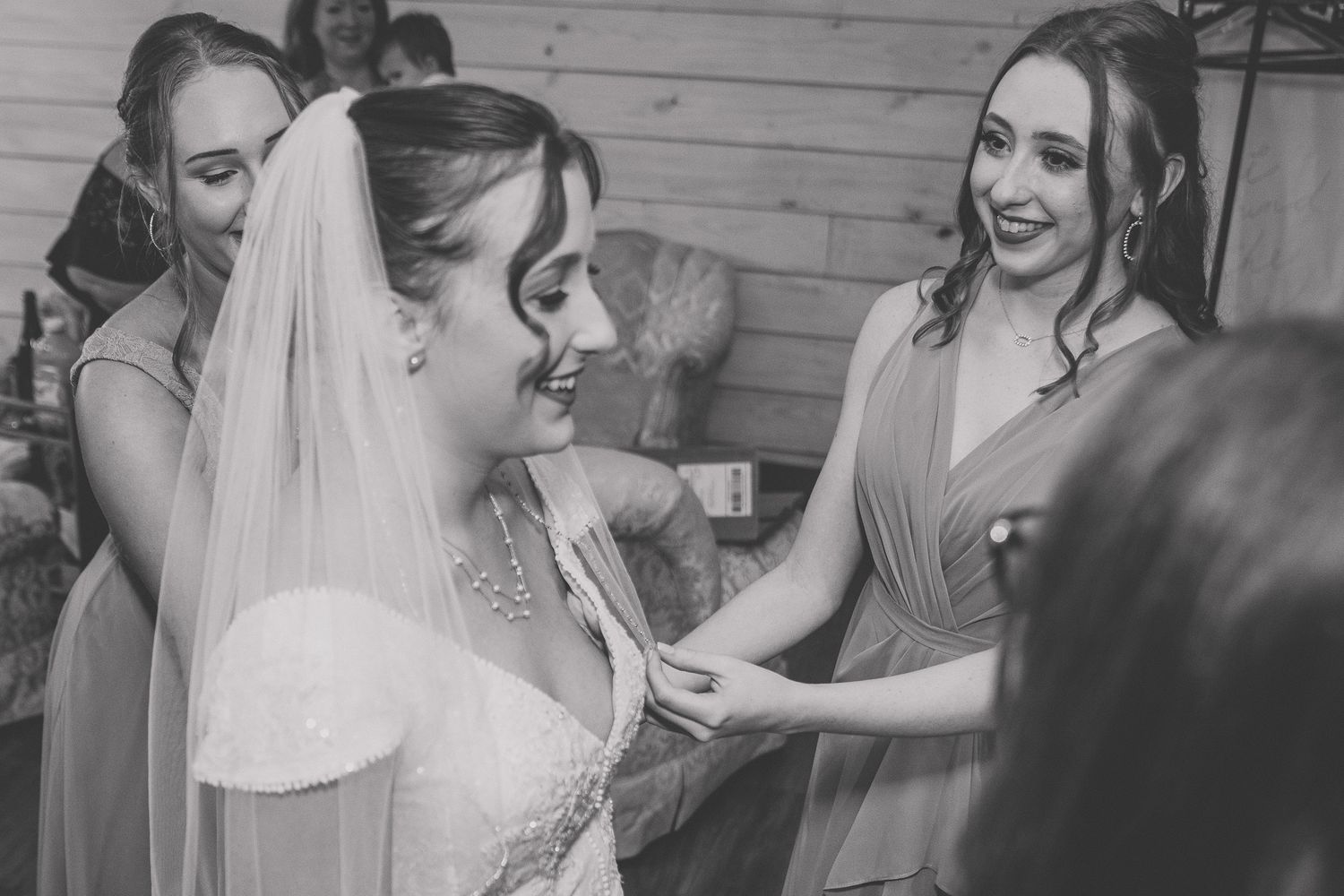 A series of black and white candid wedding photos showing emotional moments during the celebration.