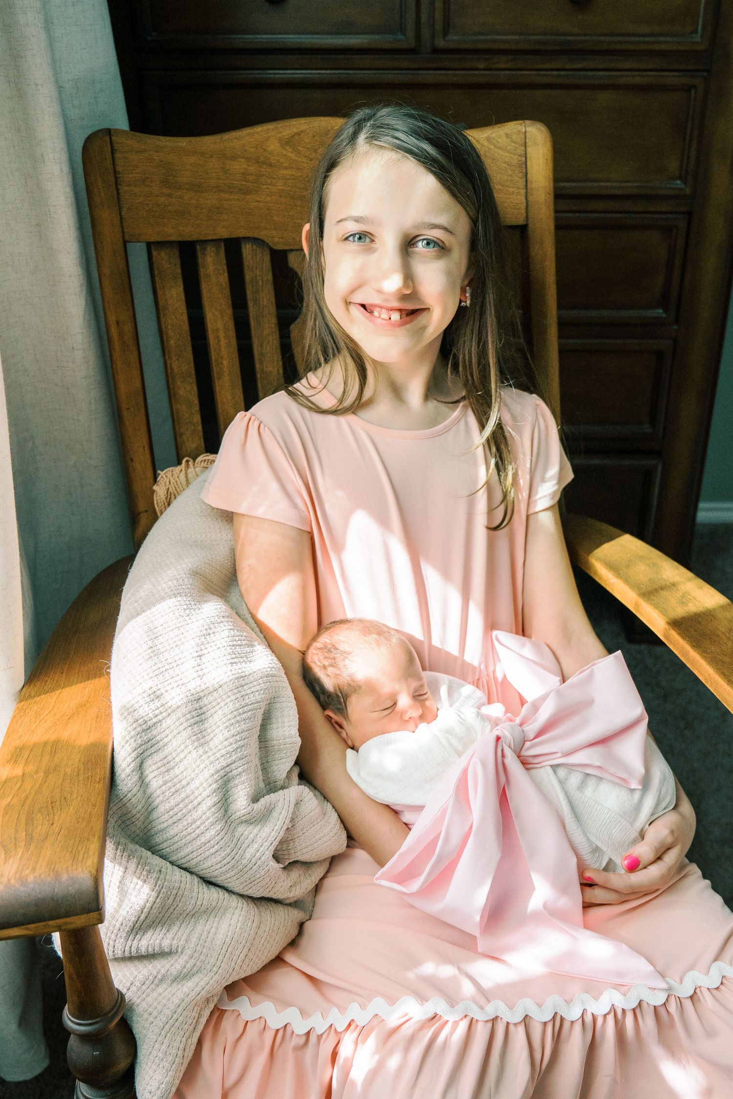 A peaceful moment in a wooden rocking chair as sunlight streams through nearby window.