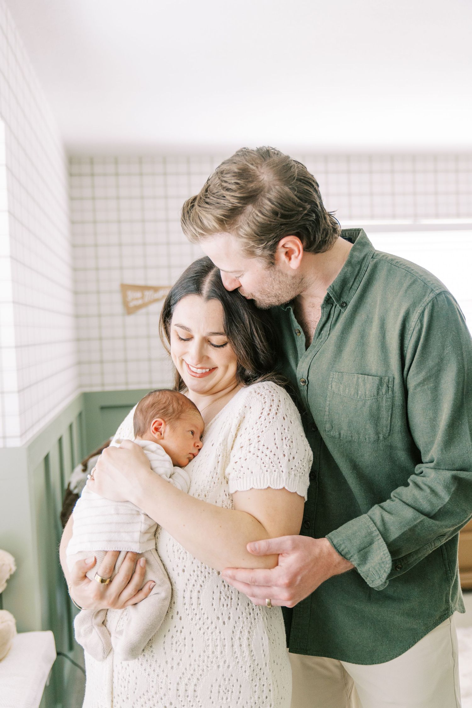 A tender family moment captured in a series of intimate photographs with a newborn baby in a bright, airy setting.