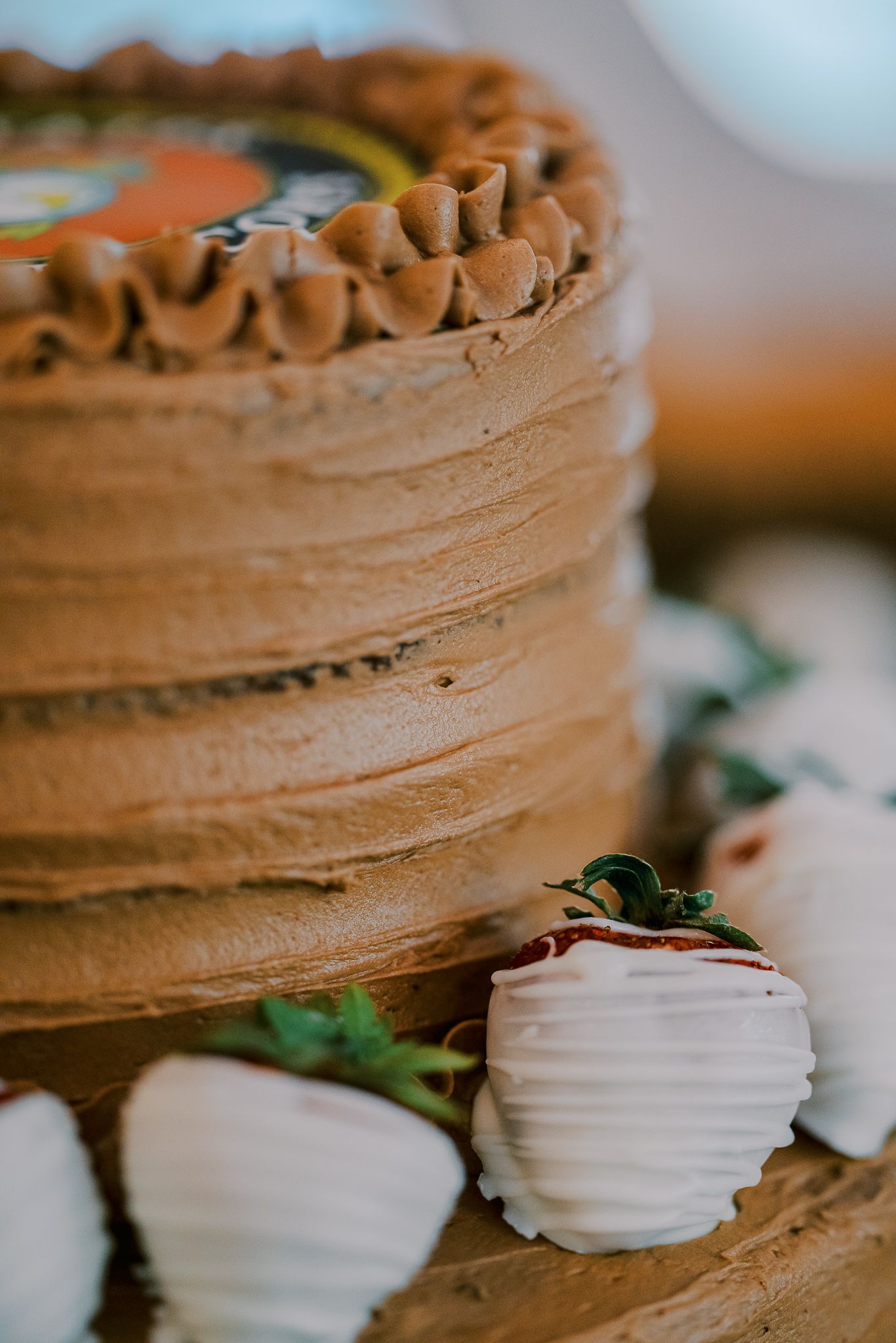 Close-up view of chocolate frosted cupcakes with white meringue decorations arranged in a row.