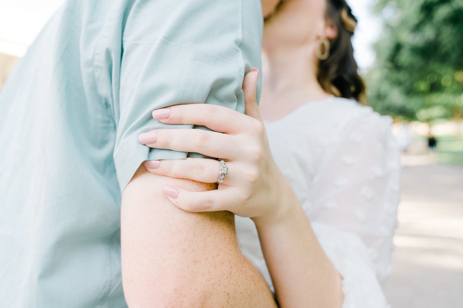 Intimate close-up photographs capturing gentle touches and tender moments in muted tones.