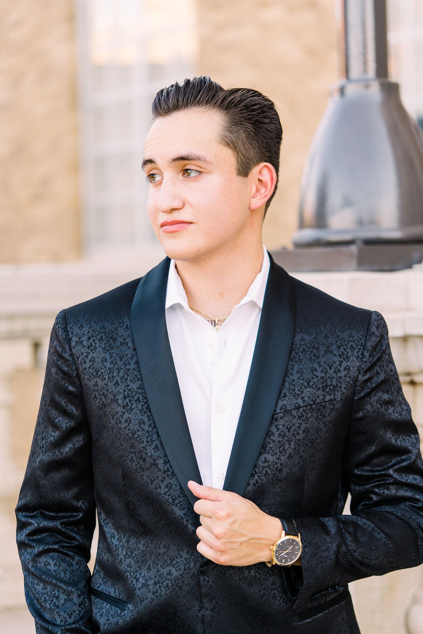 A series of fashion portraits showing a black brocade dinner jacket with white shirt against a light colored wall.