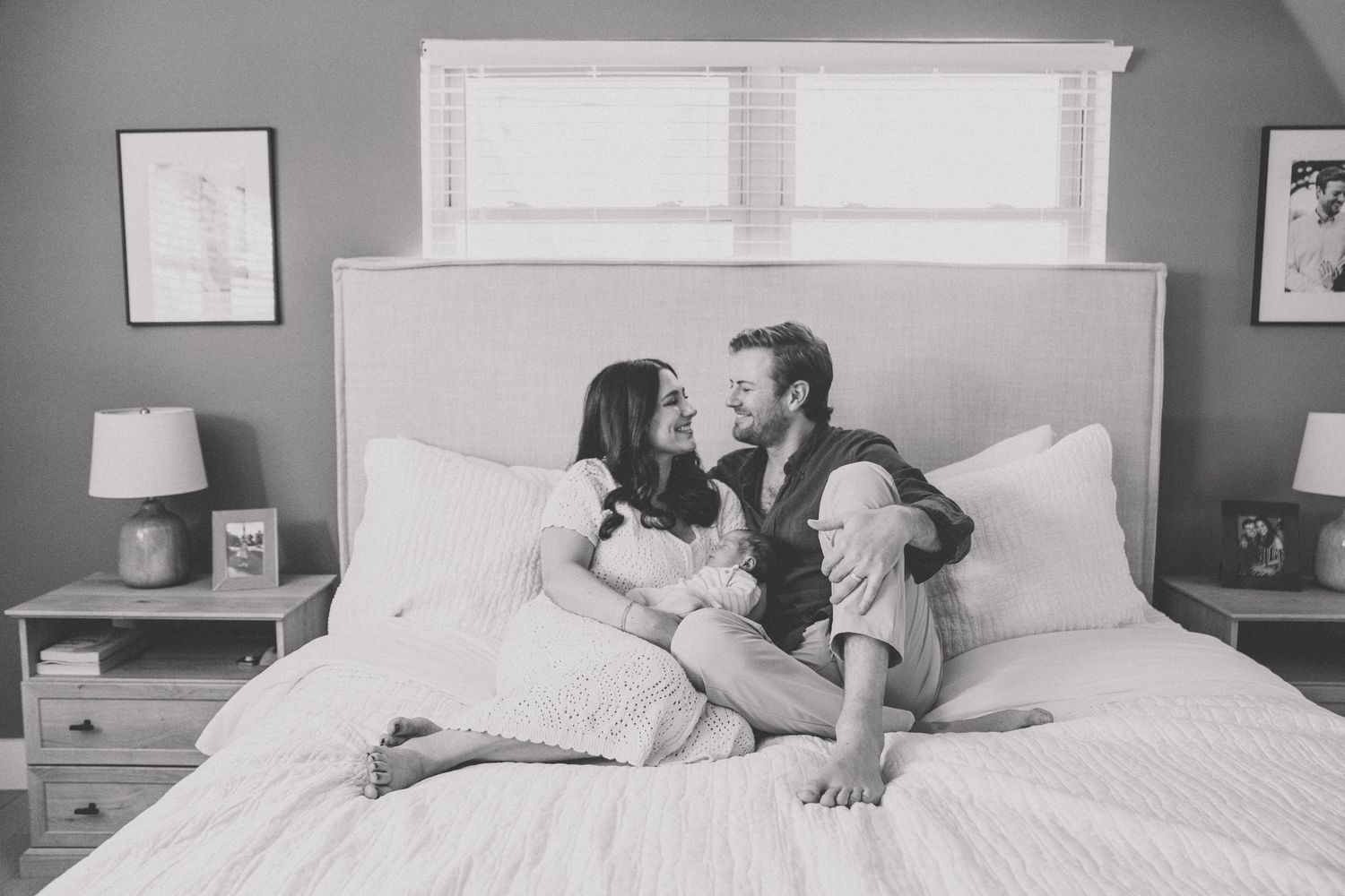 Black and white sequence showing a couple waking up and stretching in bed together.