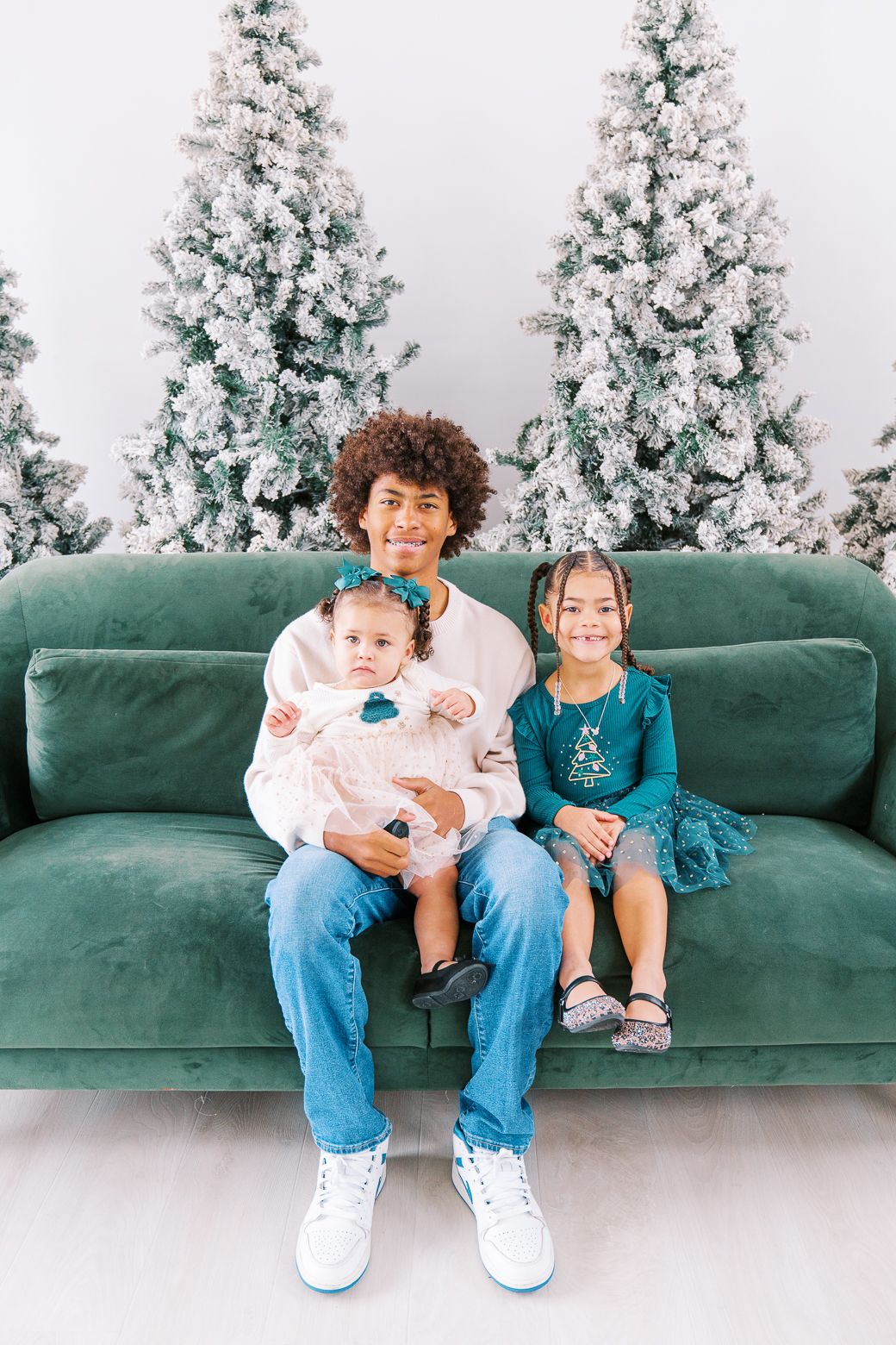 Three candid photos show children sitting on a green velvet couch with snow-covered trees in the background.