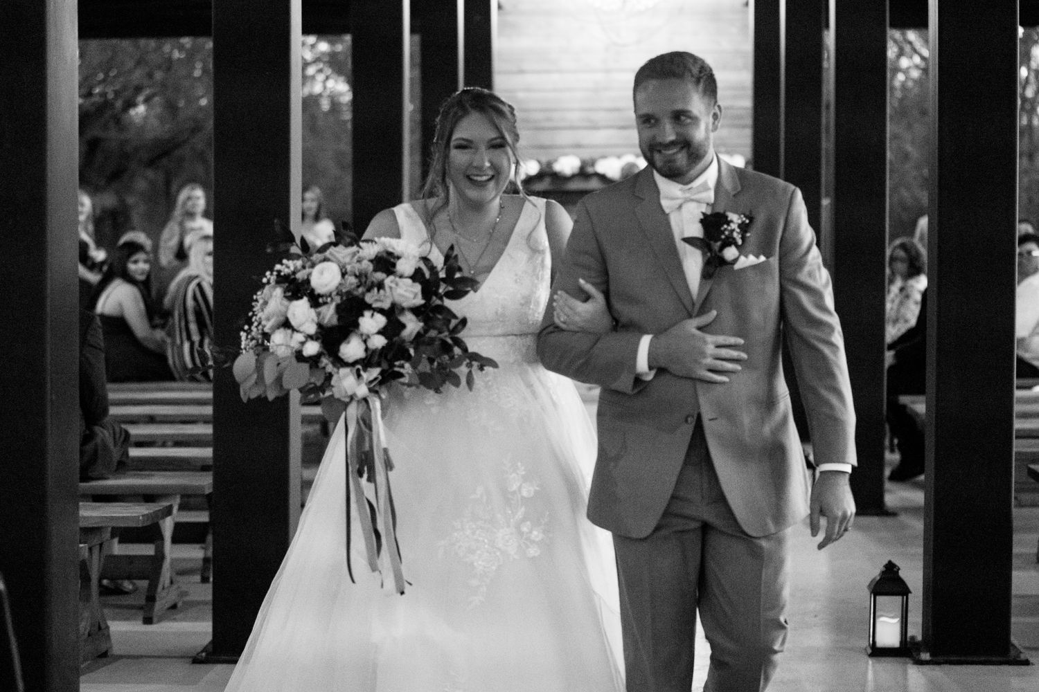 A series of black and white wedding photos showing intimate moments between a couple at their rustic venue.