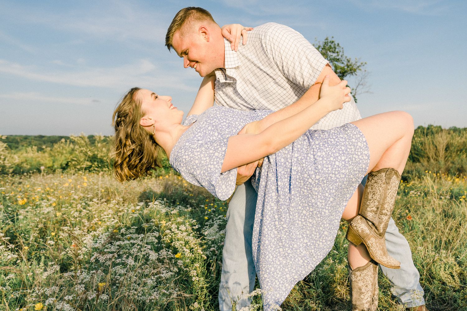 A romantic dance sequence captured in a flowering field during golden hour.