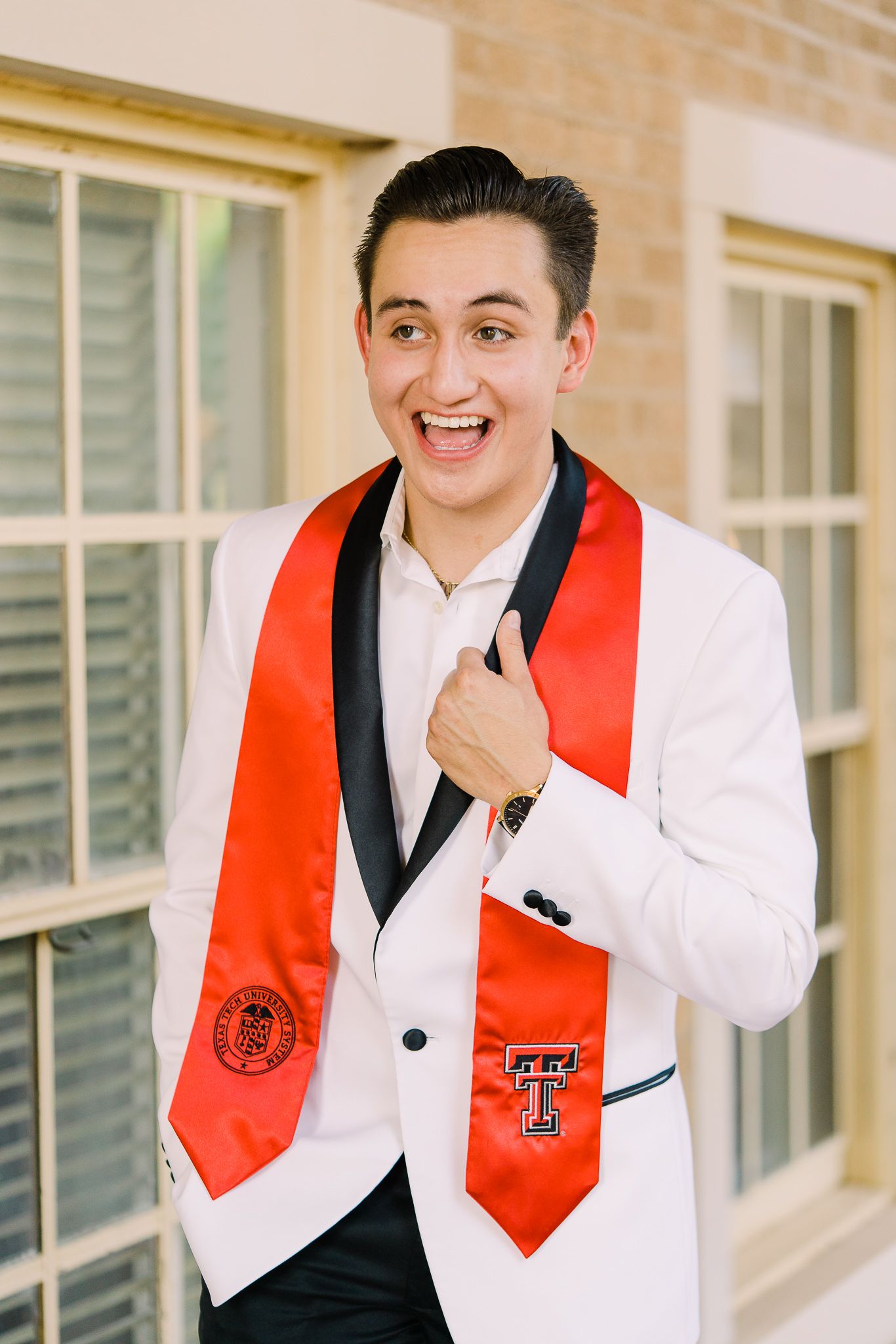 Three images of graduate in white suit and red stole posing against brick wall with Texas Tech University emblem.