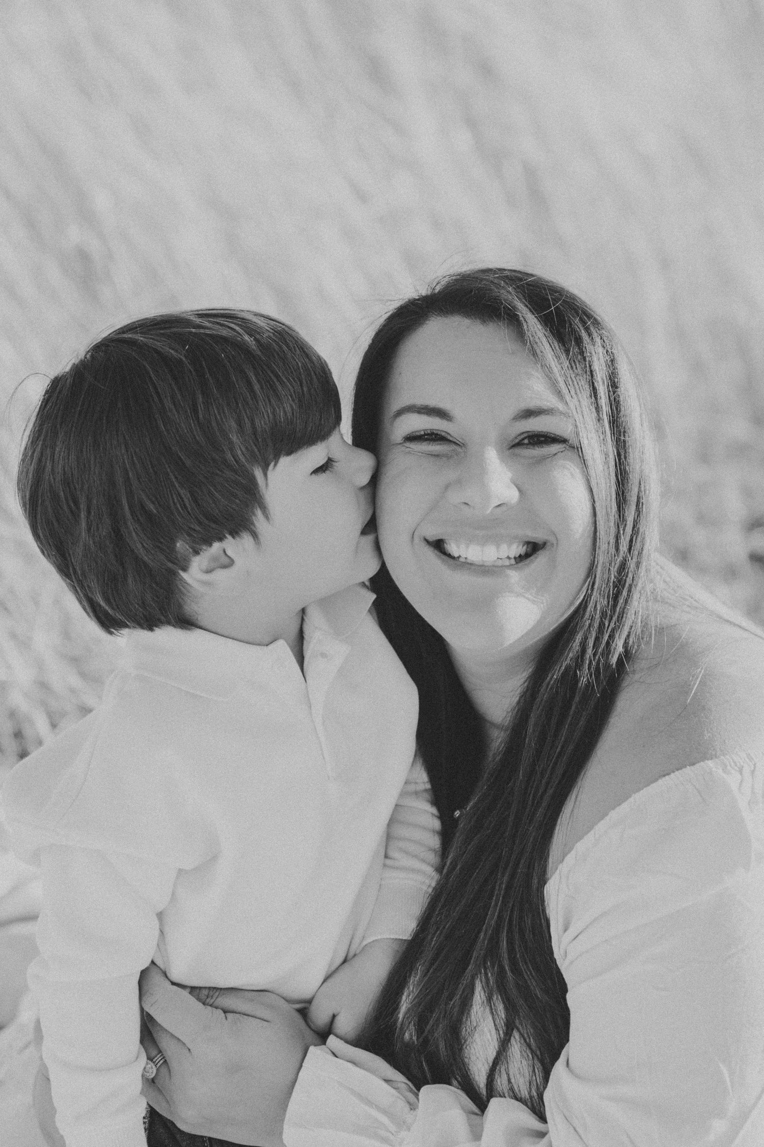 Black and white portrait of tender family moments on a bright day.