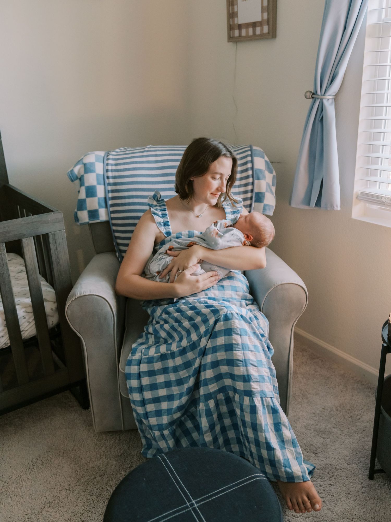 Intimate feeding moment between parent and infant in a nursery with soft natural lighting.