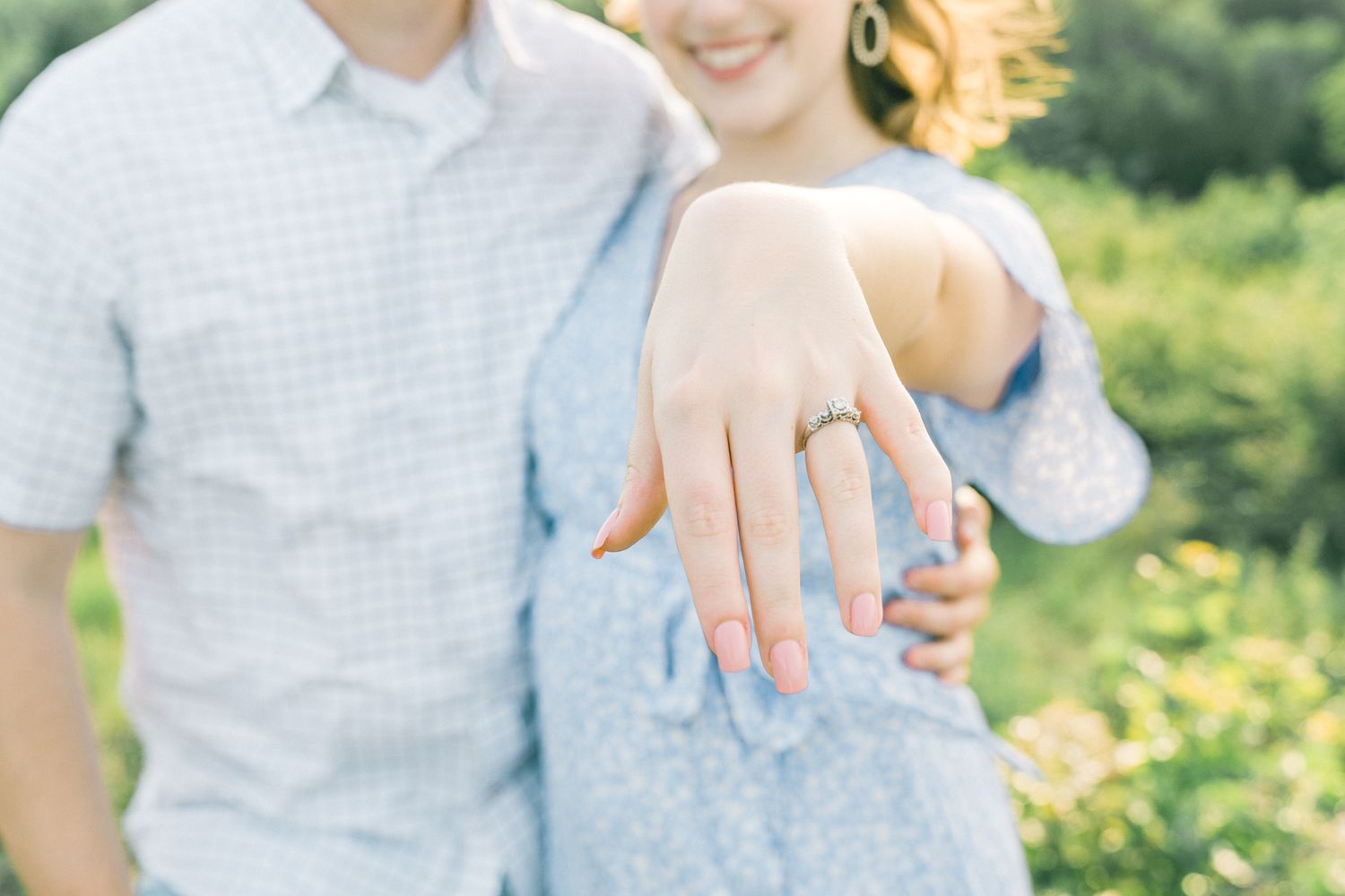 Candid outdoor portrait showing affectionate interaction between couple.
