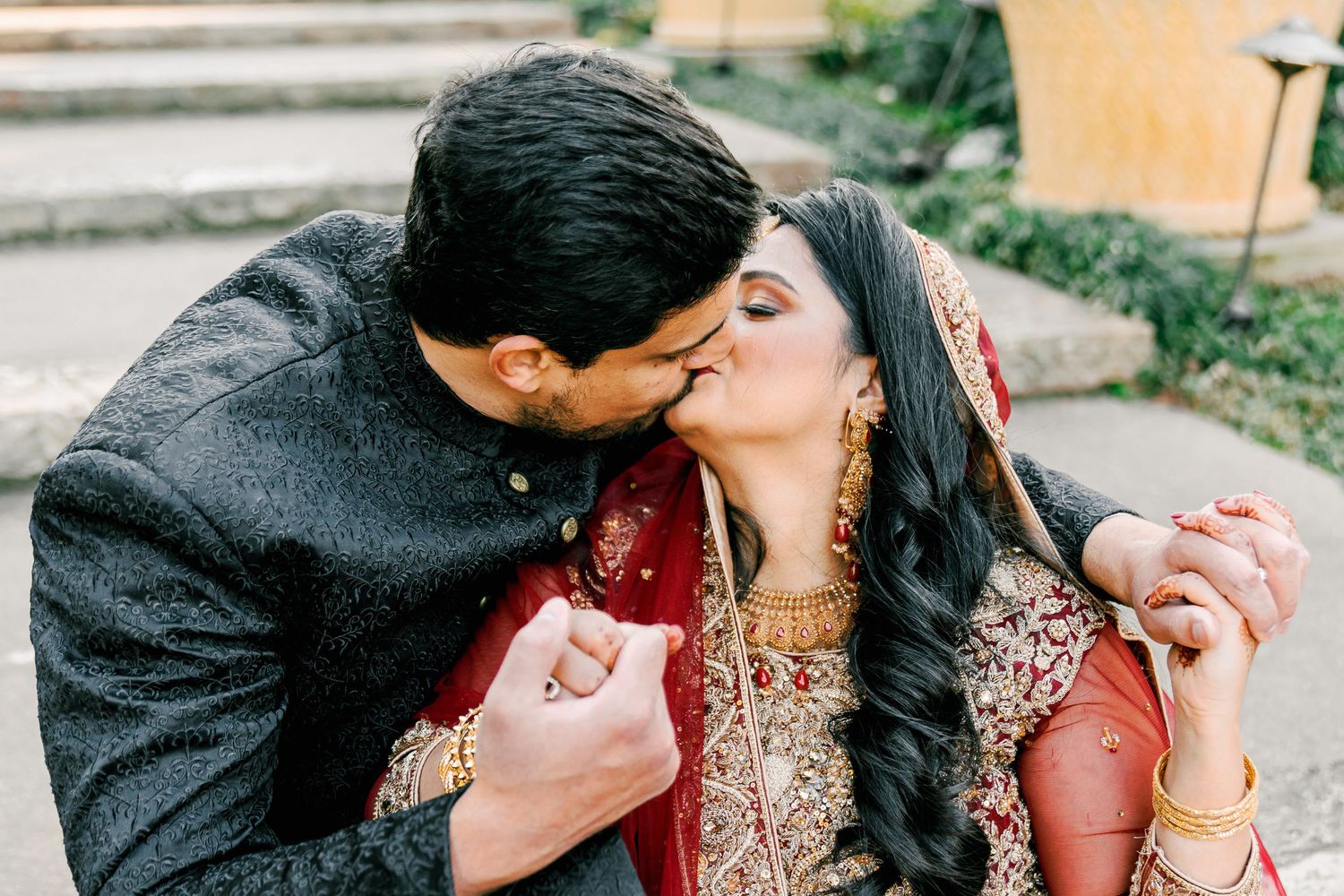 A romantic couple embraces in formal attire during an outdoor photo session.